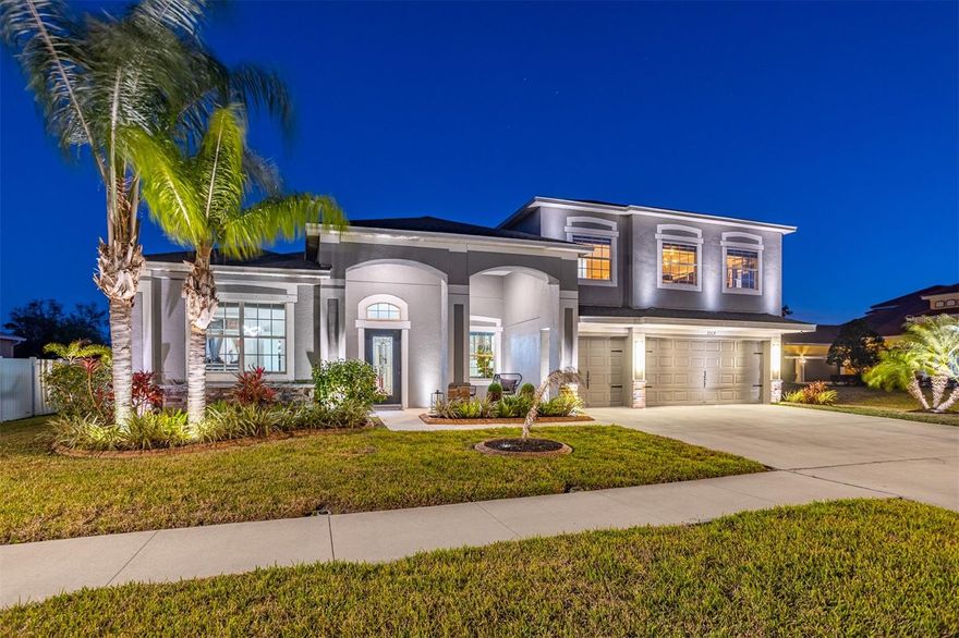 Experience the pinnacle of waterfront-adjacent luxury at 2504 Cumberland Cliff Drive, a masterfully curated estate situated in the prestigious gated enclave of River Bend in Ruskin, FL. This residence offers an unrivaled lifestyle, combining sophisticated interior design with a private outdoor resort, all just steps from the serene Little Manatee River and the community’s private dock and canoe launch.

Every inch of this nearly 3,900-square-foot sanctuary has been reimagined for the modern connoisseur. The home features a complete absence of carpet, replaced by the seamless installation of luxury vinyl plank, upgraded tile, and professional high-gloss epoxy finishes. The architectural integrity is elevated by bespoke crown molding and custom-cased windowsills throughout, complemented by upgraded oversized baseboards and designer lighting that casts a warm glow across the open-concept living spaces.

The gourmet chef’s kitchen serves as the heart of the home, featuring premium stone surfaces, high-end stainless appliances, and a social layout that flows effortlessly into the grand family room. For the collector, a stunning custom-built, LED-backlit wine wall provides a sophisticated focal point for entertaining. Nearby, a sleek electric fireplace creates a chic atmosphere for evening relaxation.

Retreat to the primary suite to discover a boutique-style luxury walk-in closet. Custom-built to showcase your finest collections, it features high-end millwork, a center organization island, and designer pendant lighting. The spa-like en-suite bath offers a garden soaking tub and a seamless glass walk-in shower.

The transition to outdoor living is spectacular. Beyond the sliding glass doors lies a brand-new 2024 heated saltwater pool and integrated spa, encased in an expansive screened enclosure. The L-shaped covered lanai is ready for ultimate entertaining, featuring a built-in summer kitchen and grill area along with vast extended paver decking. As the sun sets, professional exterior landscape lighting transforms the property into a glowing oasis.

Key structural upgrades include a new roof installed in 2023 for total peace of mind and a spacious 3-car garage with professional epoxy flooring. Living in the gated River Bend community grants exclusive access to a state-of-the-art fitness center, professional tennis and basketball courts, a playground, and an Olympic-size resort pool with a splash pad. Residents also enjoy a private community dock and boardwalk providing direct access to the Little Manatee River.

This is more than a home; it is a turnkey masterpiece designed for those who demand the absolute best in Florida luxury living. Whether you are looking for a modern sanctuary or an entertainer’s dream, this Ruskin jewel is ready for its next owner.