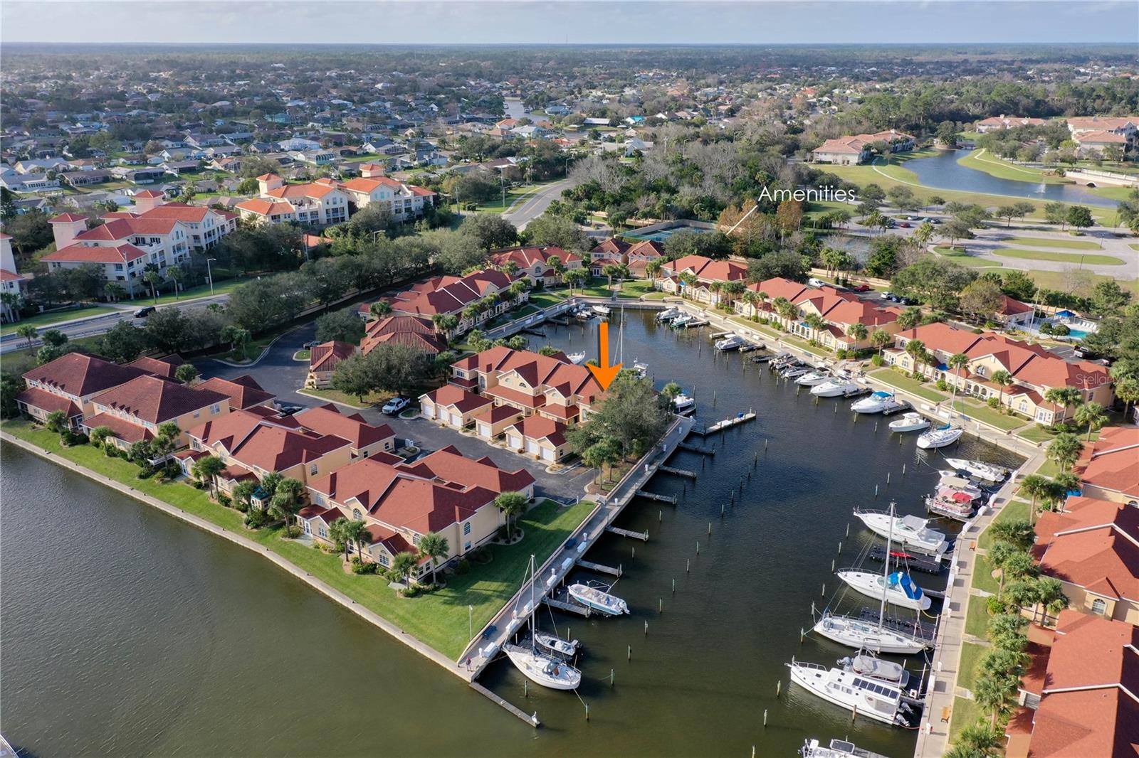 Welcome to Marina Cove and Beautiful waterfront boat basin views! Step through the gated entry and begin your waterfront lifestyle. This rare Admiral floor plan, one of only three in the community, offers stunning water views from three sides, including from the detached 2-car garage. A charming courtyard leads to your private entry. Inside, the first floor features a spacious primary suite with serene water views, a walk-in closet, and an en-suite bath with jetted spa tub and enclosed shower. Perfect for entertaining, the main level includes a powder room, wet bar, dining area, and a sun-filled living room with soaring 2-story ceilings and panoramic basin views. The kitchen comes fully equipped with all appliances, including a 2022 stainless steel induction range, microwave, refrigerator, plus 2018 dishwasher, washer/dryer, and upgraded garbage disposal. Double sliding glass doors open to your Florida room and out to the basin—ideal for morning coffee or evening relaxation. Upstairs, two guest bedrooms (one currently used as an office) enjoy water views, along with a loft area perfect for a gym, reading nook, or music lounge. A full bath with tub/shower completes the second floor. Resort-style amenities include a pool, tennis, pickleball, putting green, clubhouse, shuffleboard, and a scenic gazebo on the Intracoastal for sunrise views. Boat slips are available separately for sale or lease. HOA fees cover water, sewer, trash, insurance, grounds, underground utilities, and gated security. Walk to the European Village for dining, events, and the Sunday Farmers Market. Ask your agent to forward you the Professional video, its like being there.