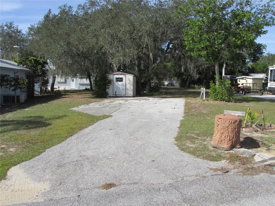 Are you looking for a place to park your RV for the winter? You just found it!  This lot is value priced and ready for it's new owner. Located in the pet friendly 55+ gated community of Saddlebag Lake Resort, you can come for the winter or live here year round.  The lot has an asphalt parking pad with space for a patio, and a shed for all your gear.  It's nicely shaded at the back, and the tree has a lovely staghorn fern. Full hook-ups will keep your RV with power, water and sewer for maximum comfort, plus the resort has two laundry facilities for your convenience.  Enjoy all the resort has to offer, including a crystal clear pool, screened-in hot tub, professional grade shuffleboard courts, horse shoe pits, tennis and pickle ball courts and driving range. You can spend your days on the water, boating and fishing in Saddlebag Lake. There's a lakeside beach house with a full kitchen that you can use at no cost for events, just reserve it. Join a club that fits your interests, or get to know your neighbors at the clubhouse. Your dogs will be happy running around at the dog park, and there's a new dog wash station to keep them clean. You'll live like you're on vacation every day here!  You don't even have to leave to get your mail, there's a post office onsite.  The low HOA covers your water, sewer and trash pick up and use of all the amenities.  What are you waiting for?  Call now for your private tour and you'll be on your way to living the good life!