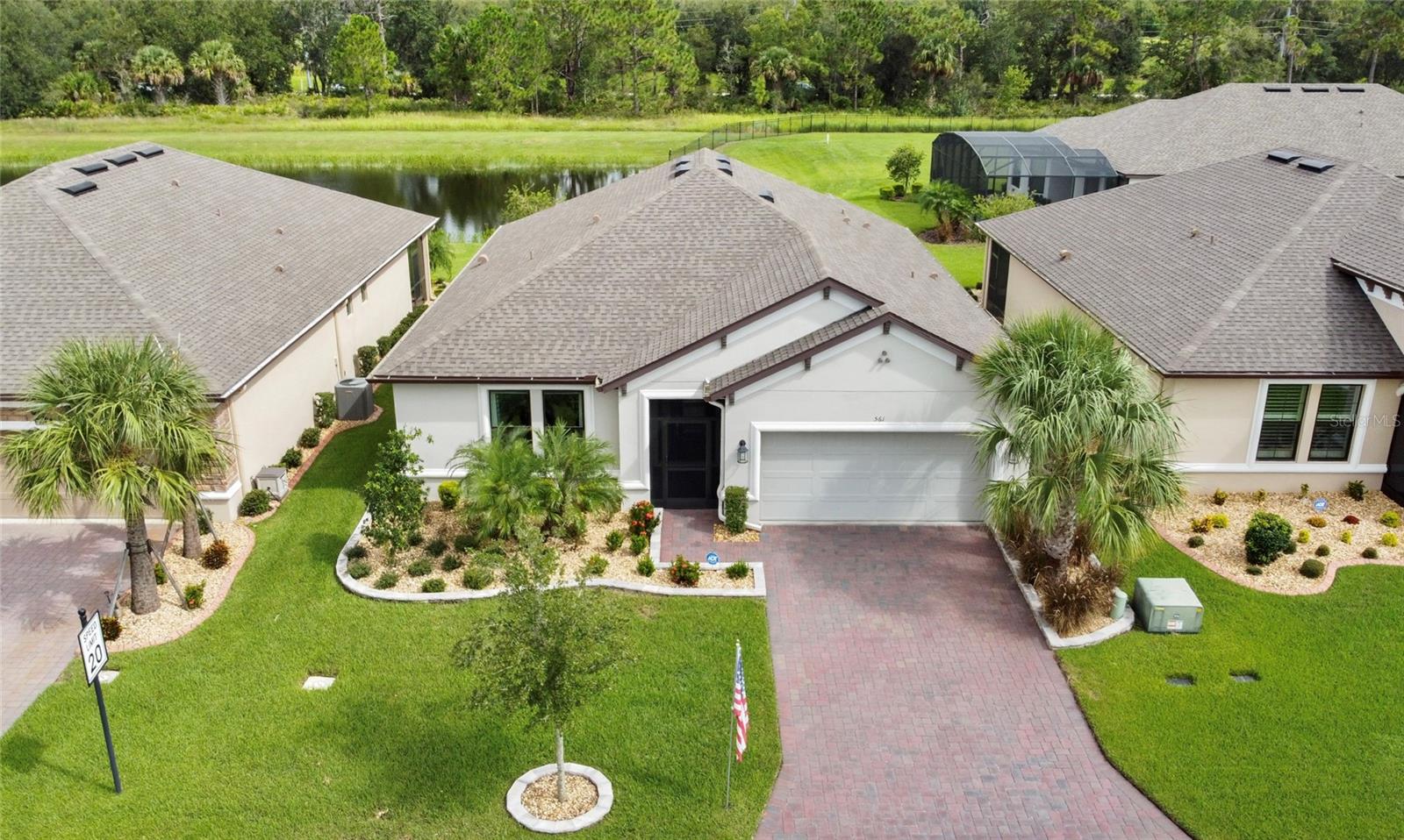 This gorgeous and highly sought-after Brava model, BUILT IN 2022 and located in the desirable Vittoria neighborhood of Solivita, offers tranquil WATER VIEWS for a truly relaxed setting. The FRONT SCREENED-IN PORTICO leads to an elegant LEADED GLASS entry door, opening to a warm and welcoming foyer with TRAY CEILINGS that immediately make the home feel inviting and comfortable. From there, the OPEN -CONCEPT floor plan showcases beautiful PLANK TILE flooring and a sleek custom-built entertainment center. The GOURMET KITCHEN is a true showstopper, boasting QUARTZ countertops, a stylish ceramic tile backsplash, 42-inch solid wood cabinets with ROLL-OUT SHELVES, and stainless steel appliances—including a wall oven and microwave combo. A closet pantry with custom built ins provides additional storage, making this kitchen as functional as it is beautiful. Dining room opens to the lanai, perfect for entertaining. A POCKET SLIDER seamlessly opens the living space to a spacious COVERED and SCREENED lanai, complete with electronic shades, where you can relax and enjoy tranquil water views year-round. The PRIMARY SUITE is a peaceful retreat featuring a BAY WINDOW bump out, cozy carpet, relaxing water views, custom drapes with ELECTRIC SHADES, and a spa-like ensuite bath. The bath offers a spacious OPEN- ENTRY SHOWER with corner bench seating, raised vanities, DUAL SINKS, and a huge walk-in closet with custom shelving to keep everything organized. For added convenience, the laundry room offers optional direct access to the walk-in closet, while the nearby drop zone includes additional built-in cabinetry for even more storage.Two additional bedrooms at the front of the home provide privacy for guests and family, each featuring custom-built shelving in their walk-in closets. An adjacent full bathroom with tub/shower combo adds convenience. Additional upgrades include a recently added (2025) GERMICIDAL UV LIGHT in the air handler and a whole-house WATER SOFTENER. The two-car garage offers OVERHEAD STORAGE RACKS, providing extra usable space. This award-winning 55+ community offers an abundance of amenities, including multiple clubhouses, fitness centers, swimming pools, tennis and pickleball courts, golf, walking trails, dining options, and over 200 clubs to join. All of this is set within a beautifully landscaped, guard-gated community just minutes from shopping, dining, and Central Florida attractions. Don’t miss the opportunity to make this stunning home your own—schedule your private showing today! The HOA: - maintains the LANDSCAPING & IRRIGATION systems in the common areas as well as at individual homesites - maintains the roads throughout the community - PROVIDES SECURITY with gate guards and mobile patrols including the Polk County Sheriff - allows AUTOMATED GATE ACCESS for residents via license plate readers - provides residents with Fiber Optic Internet & TV service.***Poinciana Lakes Plaza is a MAJOR NEW SHOPPING CENTER that opened directly across from the Solivita Main Gate in Summer of 2024. It features Sprouts Grocery, TJ MAXX, Ross, Burlington, Rack Room Shoes, 5 Below, Ulta, Outback, First Watch, 5 Guys, Urgent Care, Dentist, TD Bank, Petco & Hair Cuttery PLUS MORE TO COME.***