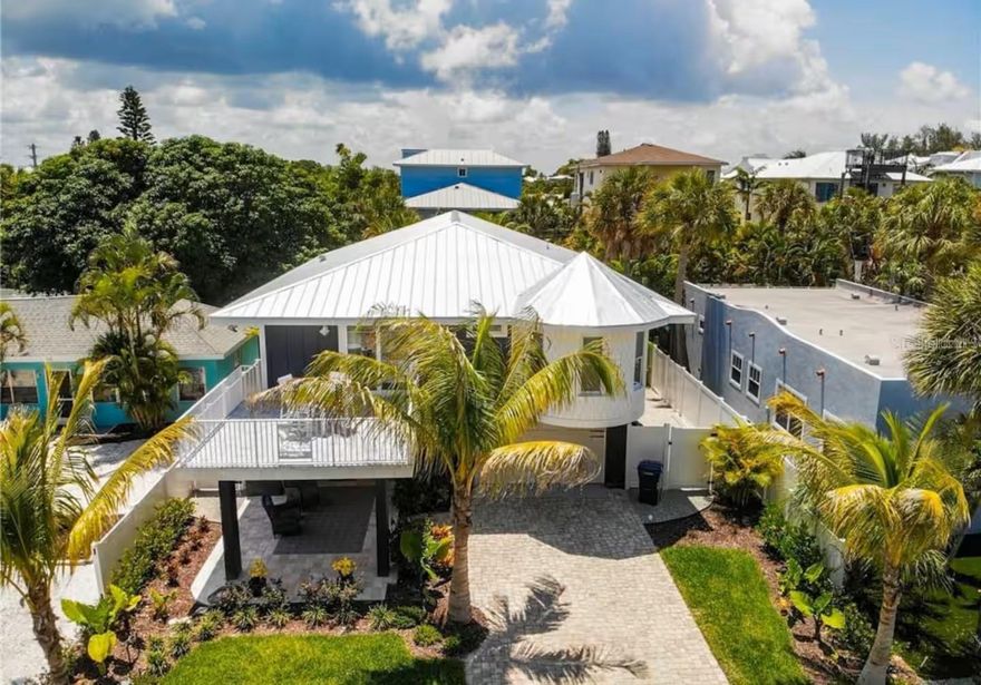 AMAZING HOME "BLUE CRUSH" ONLY 4 HOUSES TO THE BEACH!!! LOCATIONS LIKE THIS ARE RARELY AVAILBLE WEST OF GULF DRIVE! This exquisite retreat offers the perfect blend of luxury, comfort, and convenience. As you step inside, you'll immediately be drawn to its enticing features. This home has been updated with no expense spared to bring it up to todays standards. Hosting gatherings becomes a delight with the updated and fully equipped kitchen, ensuring seamless meal preparation and service, especially for those poolside occasions with family and friends. The interior of this 3 bedroom, 3 bathroom haven is designed for both comfort and style. The living area, adorned with pocket sliding doors, seamlessly connects to a spacious outdoor deck, creating a harmonious indoor-outdoor living experience. Picture evenings spent watching TV, feeling the gentle breeze, and sipping drinks on the balconies. The kitchen, featuring granite countertops and stainless-steel appliances, is a chef's delight, making cooking a pleasure. An outdoor dining table on the deck provides an ideal setting for enjoying your culinary creations. The sunlit primary bedroom, with a private balcony and a luxurious ensuite bathroom, provides a dreamy retreat. Additional bedrooms include a second bedroom with balcony access and ensuite , a third bedroom with pool deck access, and an additional space could serve as a fourth bedroom, featuring bunk beds. The tropically landscaped backyard is a haven for relaxation. The stunning pool, complete with a sun shelf, invites you to bask in the Florida sun, while the expansive covered patio provides a shaded retreat for family conversations, refreshments, and games. Prime location allows for easy exploration of Pine Avenue's boutiques and culinary delights. Beach access is just a few steps away, offering warm turquoise waters and soft sand. Take a leisurely stroll to Anna Maria Island City Pier or enhance your stay with activities like chartering a fishing trip, a sunset cruise, or paddleboarding through the mangroves. Property is currently a successful rental and has forward bookings in place. Perfect for a second home or investment property. Experience the epitome of island living!