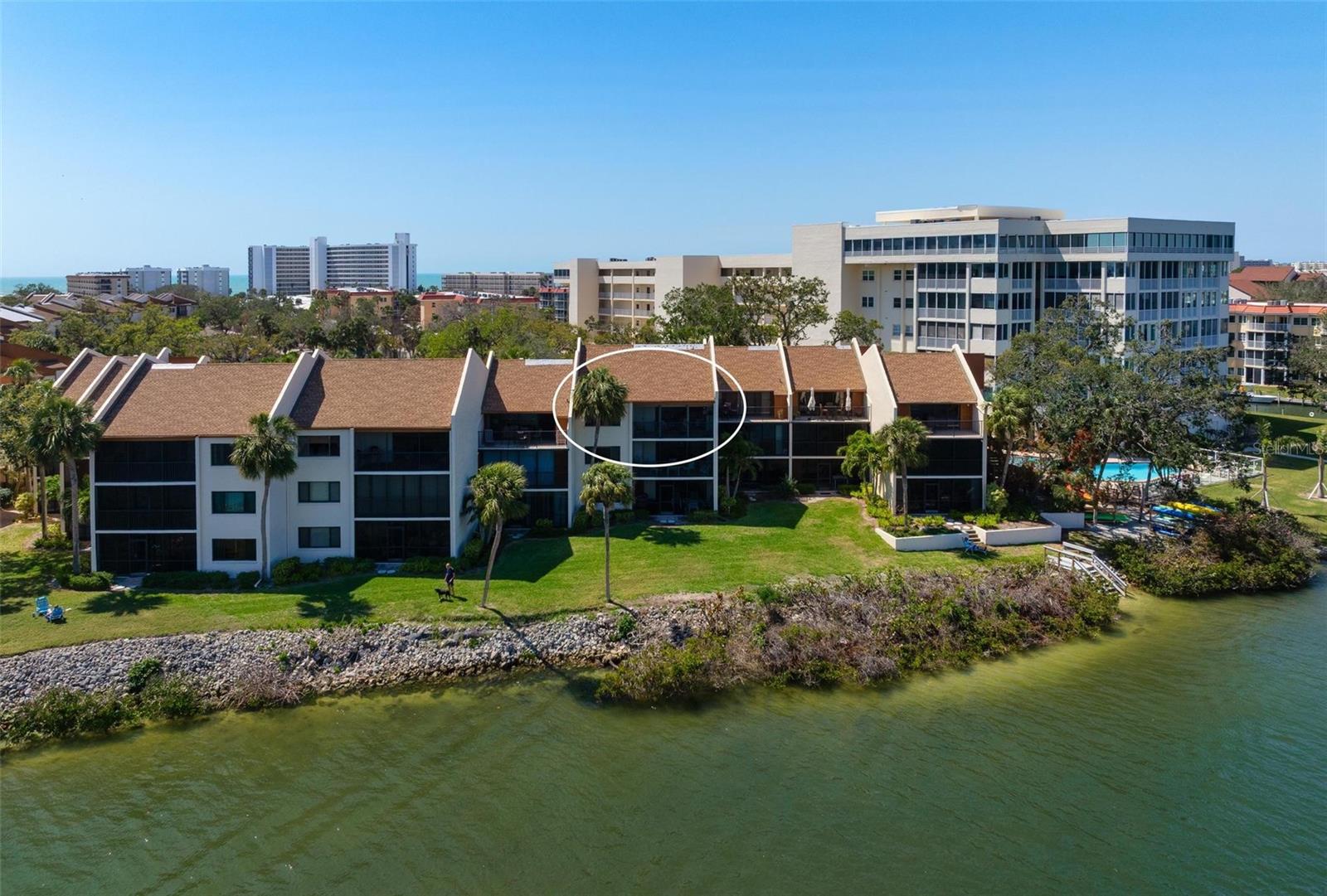 Welcome to this stunning top-floor condo on Siesta Key, offering breathtaking, panoramic views of the Intracoastal Waterway, a playground to wildlife and impressive boat traffic year-round. This meticulously maintained property combines luxury, comfort, and serene waterfront living, all within steps of the world-renowned Siesta Key Beach. Upon entering, you’re greeted with an expansive open concept living area that’s flooded with natural light, thanks to large windows that frame the incredible views of the water and lush surroundings. The spacious living room seamlessly connects to the screened terrace, ideal for savoring the saltwater breeze while enjoying your morning coffee or evening spirits. The updated kitchen is a chef's dream, featuring granite countertops that sparkle under the updated recessed lighting, modern stainless steel appliances, ample cabinet space, and a sleek backsplash. The condo offers two generously sized bedrooms, each designed with comfort and relaxation in mind. The primary suite is generous enough to offer a small office space and additional seating alongside the comfortable and coastal inspired furnishings and features a beautifully renovated en-suite bathroom with dual vanities and a walk-in shower with modern frameless glass shower doors. With its top-floor position, this condo provides unmatched privacy and tranquility along with the community amenities, including a heated pool, clubhouse, deeded beach access to Crescent beach, direct Intracoastal access via fishing piers, boat docks available for rental, and gently meandering walking paths canopied by beautiful oak trees. Whether you’re looking for a seasonal getaway or a year-round residence, this condo provides the perfect blend of style, convenience, and coastal living. A prime location, this community is walking distance to Siesta Key’s south village with bustling shops and eateries and is convenient to Stickney Point bridge so getting on and off the island is far easier than some mid-island communities. A short trolley ride takes you to Siesta Key Village where more community, activity and entertainment awaits. This is the ultimate opportunity to own a piece of Siesta Key waterfront living, while being tucked away in your own private paradise.