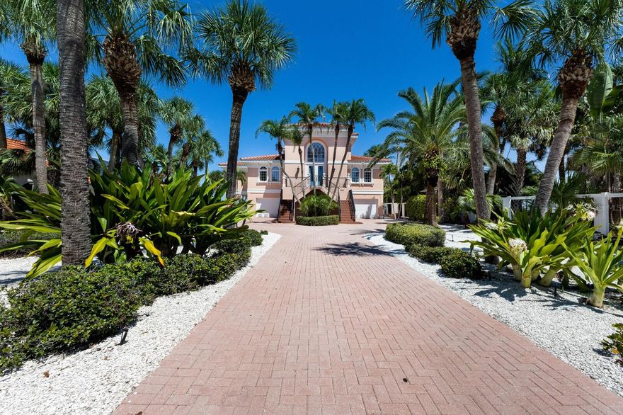 Experience Unrivaled Waterfront Living! Envelope yourself in sweeping panoramic views of Tampa Bay from this estate-sized waterfront retreat on the coveted north end of Anna Maria Island. Set on nearly half an acre and framed by lush tropical landscaping, this residence makes a lasting impression the moment you arrive. Step inside to soaring ceilings and expansive windows that bathe the interior in natural light. The open-concept design flows effortlessly, with three bedrooms—each featuring its own ensuite bath—offering the perfect blend of comfort and privacy. The spacious eat-in kitchen is designed for both everyday living and effortless entertaining. Additional highlights include an elevator, new roof, impact-rated windows, and a transferable termite warranty for peace of mind. Outside, your private beachfront oasis awaits. Relax beside the beautifully designed pool, sip champagne with your toes in the sand, and watch as the sky transforms with some of the most breathtaking sunsets on the Gulf Coast. Adding to its uniqueness, this property includes your very own deeded boat dock directly across the street on Bimini Bay—an oversized slip with a wraparound composite dock—making it a true boater’s paradise. Perfectly tucked away yet just minutes from Anna Maria’s vibrant shops, dining, and island attractions, this exceptional residence offers the ideal balance of seclusion and convenience. Don’t let this rare opportunity slip away—discover your own slice of island life today.