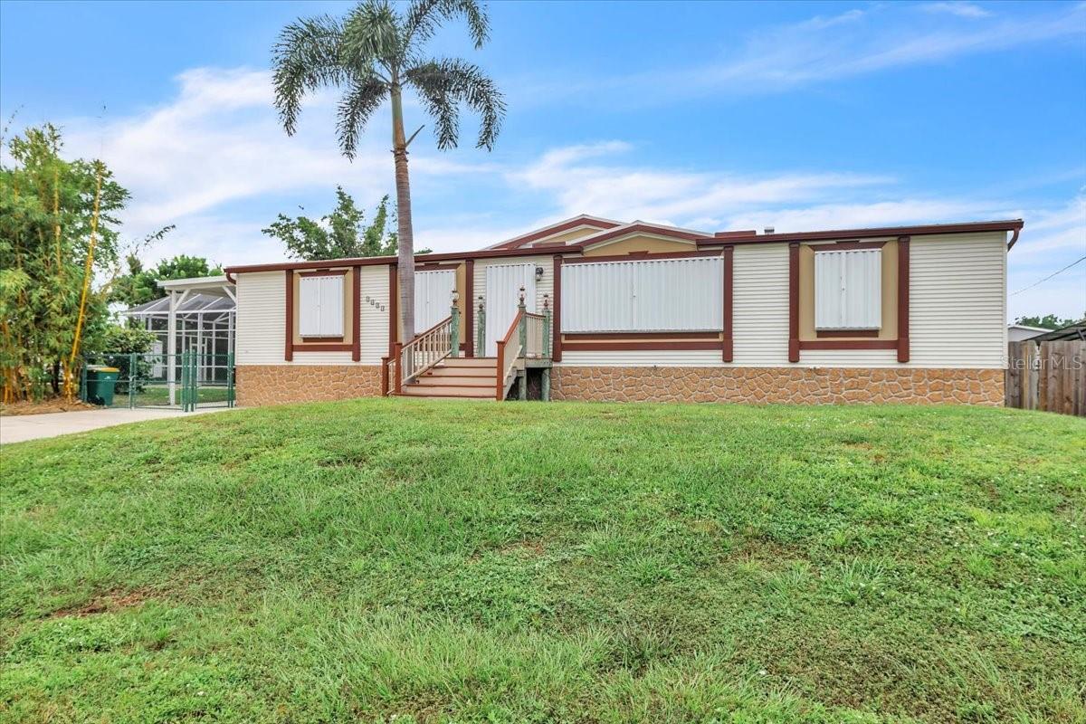 Beautiful 2005 Palm Harbor Pool Home on Saltwater Canal – 150 Ft. of Frontage! Welcome to this 3-bedroom, 2-bath, 1,800 sq. ft. pool home perfectly positioned on a wide saltwater canal with direct access to Charlotte Harbor and the Gulf of Mexico. Nestled off Aqui Esta among other beautiful homes, this property combines charm, function, and Florida lifestyle living. No flooding in the home from recent hurricanes! Built with quality in mind, the home features 3/4-inch plywood wrap on the roof, walls, and floor, a durable metal roof, and hurricane shutters for added strength, protection, and peace of mind. Set on two lots totaling 0.59 acres, this residence offers both space and versatility. Boating enthusiasts will appreciate the private wood dock and boat ramp, making this a true fisherman’s dream. Additional exterior highlights include a circular driveway, covered carport and a large storage shed. Step inside to a warm and inviting open floor plan, enhanced by luxury vinyl plank flooring, neutral tones, and tasteful accents. The cozy electric fireplace with a custom mantle creates a welcoming focal point, while the ceiling fan and breakfast bar with seating add comfort and convenience. An adjacent dining area with pendant lighting provides the perfect setting for family gatherings or entertaining. The bright, functional kitchen is designed with wood cabinetry, ample counter space, a center island with seating, and a suite of stainless-steel appliances. A large window above the sink brings in natural light, while the open layout flows seamlessly to the living and dining areas. Just off the kitchen, the laundry room offers extra storage and everyday practicality. The spacious primary suite features a large walk-in closet and a well-appointed en-suite bath with dual vanities, soaking tub, and separate shower. Two additional guest bedrooms—one with sliding doors to the lanai—also feature walk-in closets and share a full bathroom. Outdoor living shines in this tropical retreat, complete with a sparkling pool with new pool pump, flagstone decking, screened lanai, and a sturdy Bamboo Tiki Hut with summer kitchen—ideal for entertaining or simply relaxing. Whether you’re fishing from your dock, swimming in the pool, or enjoying the Florida sunshine, this home truly has it all. Close to I-75/US41 and nearby to Fishermen's Village, downtown Punta Gorda shops & restaurants, airports, great boating, fishing, sailing, and more. Home is completely spotless and waiting for you. Come enjoy the Florida lifestyle in this impressive home!
**PLEASE ENJOY THE 3D INTERACTIVE VIRTUAL TOUR ASSOCIATED WITH THIS LISTING**