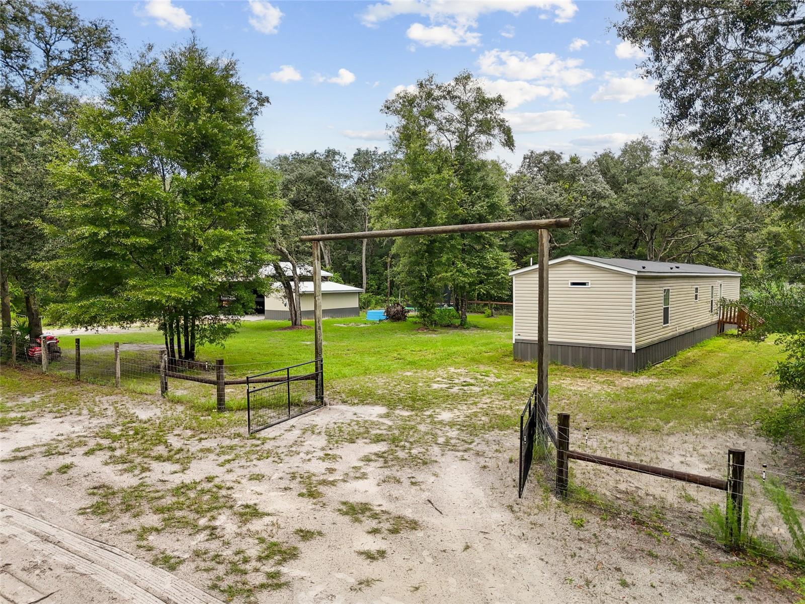 Looking for the perfect little spot in Chiefland to call your own? Well, grab your checklist, because this place is about to start ticking boxes! Need a fully fenced yard with not one but two gates? Yep, it’s got that. Need a workshop for all those “brilliant” projects your significant other gives you the side-eye over? Oh, it’s got that too. Want to be tucked away off a paved road in a quiet neighborhood? Look no further—your future hideaway awaits. This 2023 single-wide is a whopping 76 feet long (yes, that’s basically a cruise ship in mobile home terms). With 3 bedrooms and 2 bathrooms laid out in a split floor plan, you’ll have plenty of space—and the kind of privacy that keeps everyone sane. The large kitchen island is perfect for meal prep, late-night snacks, or just pretending you’re on a cooking show. When you’re done “working” in the shop, you can crash in the cozy living room. Speaking of that shop—it’s no small potatoes. Measuring 24’x48’, with a concrete floor, water, electric, and roughed-in spaces for a bathroom, a laundry room, and a outdoor kitchen on its very own septic system—it’s basically a bonus house in disguise. All that’s missing now? You, your projects, and maybe a tool or two you’ll definitely lose and then find months later.