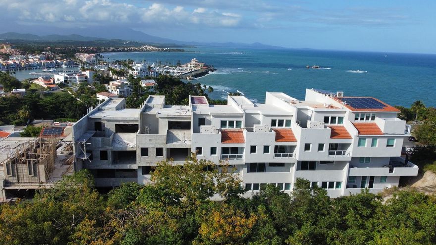 One or more photo(s) has been virtually staged. Under Construction. This 4-bedroom townhouse, currently under construction, offers the opportunity to shape a coastal lifestyle within the Breeze Point enclave of Palmas del Mar, while securing pre-construction pricing subject to adjustment upon completion.

Designed for those who value space, light, and flow, the residence offers approximately 4,400 square feet of interior living space, complemented by 1,497 square feet of balconies and terraces that invite the outdoors in. Double-height ceilings in the living area, expansive ocean views, and constant cross-ventilation create an atmosphere that feels open, relaxed, and naturally connected to the tropical setting.

Spread across five levels, the home adapts effortlessly to the rhythm of daily life. Whether hosting gatherings, working remotely, welcoming guests, or creating spaces for wellness and entertainment, each level can be tailored to reflect how you live today—and how you envision living in the future. The rooftop terrace becomes a natural extension of the home, ideal for sunset moments, evening conversations, and open-air entertaining. An elevator shaft is already in place, offering seamless potential for future convenience.

At this stage, the residence remains a blank canvas, allowing the layout and experience of each floor to evolve around your lifestyle, preferences, and long-term vision.

Set on a quiet cul-de-sac, just steps from the beach, within a gated community with 24/7 security, the property balances privacy with access to the resort-style amenities that define life in Palmas del Mar—where days are shaped by the ocean, outdoor living, and a sense of ease that carries through every season.

Schedule your private visit and experience the lifestyle potential of Breeze Point #48.