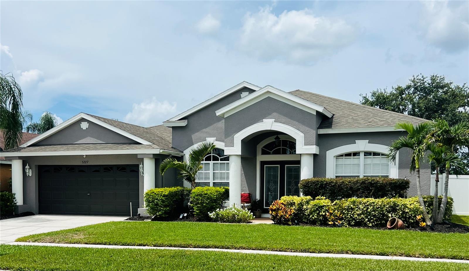 Waterfront home in sought after golf course community of Lexington Oaks. Relax and unwind on your expansive screened in covered back patio with views of the lake through your white picket fence. Double front glass doors welcome you into this spacious home and leads you into your tiled foyer. There is a separate formal dining room perfect for family dinners or entertain guests, double French doors lead into the office with cherry wood floors, and an open family room with water views through the triple sliding glass doors leading to the huge covered patio and out into the large fenced in yard. Generous amount of wood cabinets in your kitchen with tile floors, stainless steel appliances, breakfast bar, and separate dinette area. Split bedroom plan with three nice sized bedrooms on one side with a pool bath, and a spacious primary bedroom with ensuite that boasts a garden bath tub, separate glass enclosed shower, and walk in closet on the other side. This home has a separate inside laundry room with washer and dryer, ceiling fans throughout, blinds, and no carpets.