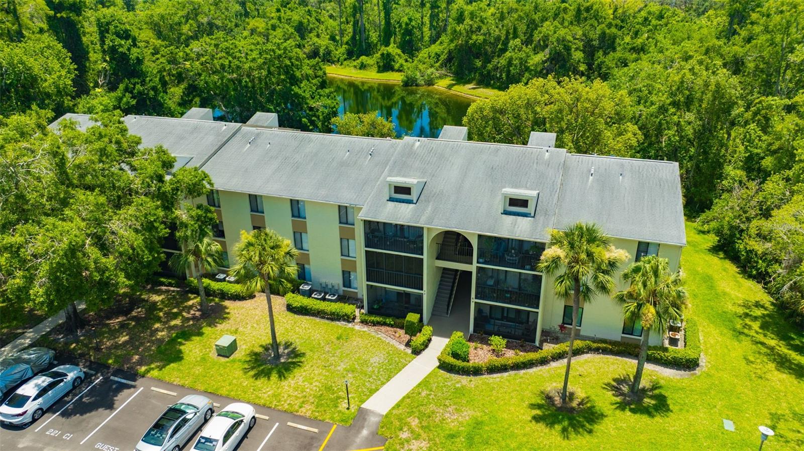 Welcome to your own slice of paradise in the heart of the East Lake corridor! This beautifully maintained 2-bedroom, 2-bath condo is nestled in the non-age-restricted community of Pine Ridge at Lake Tarpon. Enjoy peaceful water views and daily wildlife visits from your private, covered patio overlooking a serene pond and lush nature preserve—your perfect Zen retreat. Inside, you’ll find a bright and spacious open-concept layout featuring new luxury vinyl flooring in the kitchen, living and dining areas. The kitchen offers ample cabinet space and convenient breakfast bar seating, ideal for casual meals or entertaining guests. The generously sized primary suite includes a walk-in closet and en-suite bathroom with a walk-in shower. The second bedroom is equally spacious, and both bedrooms enjoy tranquil pond views. Pine Ridge offers resort-style amenities including a heated pool, spa, clubhouse, tennis courts, shuffleboard, and a playground. Centrally located near top-rated schools, shopping, dining, and hospitals—with Honeymoon Island just 30 minutes away and Tampa International Airport a quick 20-mile drive—this location is unbeatable!