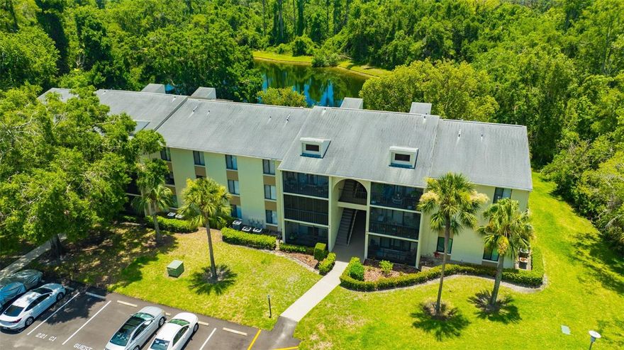 Welcome to your own slice of paradise in the heart of the East Lake corridor! This beautifully maintained 2-bedroom, 2-bath condo is nestled in the non-age-restricted community of Pine Ridge at Lake Tarpon. Enjoy peaceful water views and daily wildlife visits from your private, covered patio overlooking a serene pond and lush nature preserve—your perfect Zen retreat. Inside, you’ll find a bright and spacious open-concept layout featuring new luxury vinyl flooring in the kitchen, living and dining areas. The kitchen offers ample cabinet space and convenient breakfast bar seating, ideal for casual meals or entertaining guests. The generously sized primary suite includes a walk-in closet and en-suite bathroom with a walk-in shower. The second bedroom is equally spacious, and both bedrooms enjoy tranquil pond views. Pine Ridge offers resort-style amenities including a heated pool, spa, clubhouse, tennis courts, shuffleboard, and a playground. Centrally located near top-rated schools, shopping, dining, and hospitals—with Honeymoon Island just 30 minutes away and Tampa International Airport a quick 20-mile drive—this location is unbeatable!