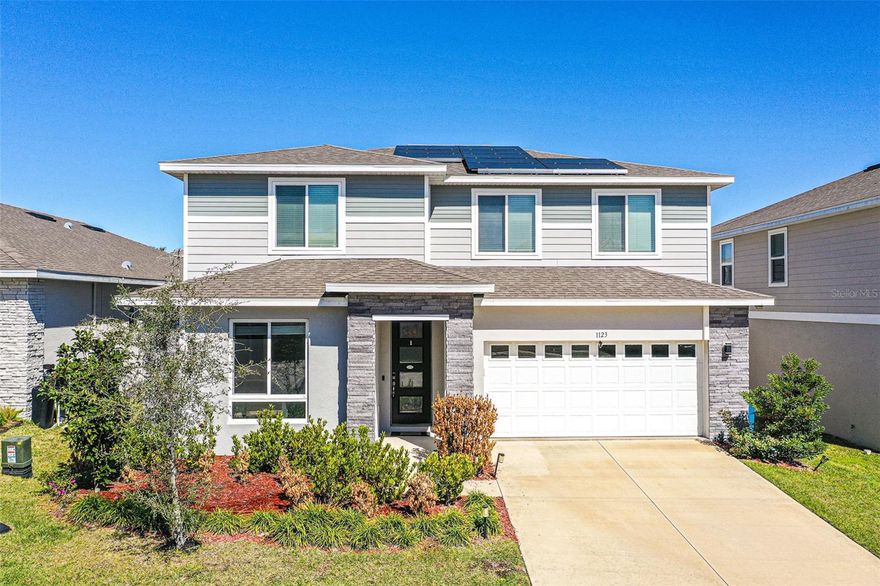 Welcome to this stunning, custom-built 2022 two-story home offering 5 bedrooms, 3 full baths, and 1 half bath — perfectly designed for both comfort and style. Everything is practically brand new, providing peace of mind along with the modern finishes today’s buyers are searching for.



The heart of the home is the truly impressive upgraded kitchen, beautifully appointed with high-end finishes, gorgeous quartz countertops, abundant cabinetry, and a layout that is both functional and eye-catching.



This spacious and thoughtfully designed floor plan includes a private in-law suite, ideal for multi-generational living, extended guests, or added flexibility. Luxury vinyl plank flooring flows throughout the main living areas, while the bedrooms offer plush carpeting for added comfort.



Retreat to the oversized primary suite featuring a generously sized bedroom and an extra-large walk-in closet with abundant storage. The beautiful en-suite bath creates a relaxing, spa-like atmosphere you’ll love coming home to.



Upstairs, you’ll find a versatile loft area perfect for a playroom, home office, or additional flex space, along with a conveniently located laundry room offering extra storage and easy access near the bedrooms.



Step outside to enjoy a large backyard complete with a spacious screened-in porch — the perfect setting for relaxing evenings, entertaining guests, or enjoying Florida living year-round.



The exterior is enhanced with upgraded stone accents that add striking curb appeal and architectural character. Energy-efficient solar panels are already installed, and the lease can be seamlessly transferred to the new owner.



Located in a desirable community featuring a beautiful community pool and playground, this move-in-ready home offers the perfect blend of modern construction, thoughtful upgrades, generous outdoor space, and fantastic neighborhood amenities. Also located in the heart of Central Florida! This home offers quick access to Orlando’s top attractions. Walt Disney World, Universal Orlando Resort, and SeaWorld are all just a short drive away, along with plenty of shopping, dining, and major highways for everyday convenience.