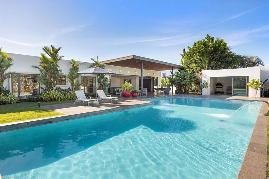 Nestled within the exclusive Santa Maria neighborhood in San Juan, this stunning one-story residence is ready for you to move in and make it your own. Boasting unparalleled privacy, this property offers a serene and peaceful living experience in one of the city's most prestigious enclaves. 
 
This exquisite home features 4 bedrooms and a total of 6.5 bathrooms, making it the perfect space for both family and guests. The basement-flex space is ideal for a man cave, playroom, or wine cellar, and the laundry and maids' room add convenience to daily life. The spacious 3-car garage even comes equipped with an electric charger for added convenience.
 
The 5660 ft.² home sits on a 2034 m² lot and is sold completely furnished, so you can move in and start enjoying your new home right away! The Leicht kitchen from Arkitectura is equipped with top-of-the-line appliances, and the full glass impact-proof windows in each room provide stunning views of the lush greenery outside.
 
As you walk out into the high-ceilinged outdoor terrace, you'll be surrounded by the magnificent landscaping, a big pool with fountain, and lots of green areas. The patio and landscape are equipped with beautiful accent lighting throughout, and a sprinkler system with timers keeps everything looking pristine. Outside, you'll find a guest quarter with a full bath that's ideal for use as an office or gym. And for basketball lovers, there's even a half-basketball court!
 
Residents of this exclusive community have access to San Francisco's Tennis Club, basketball courts, soccer, and baseball fields, providing ample opportunities for sports and recreation. The location is also very accessible, making it easy to get to and from all your favorite destinations. Don't miss out on the opportunity to own this luxurious and stunning home in Santa Maria, San Juan. Schedule your tour today and get ready to start living the life of your dreams!