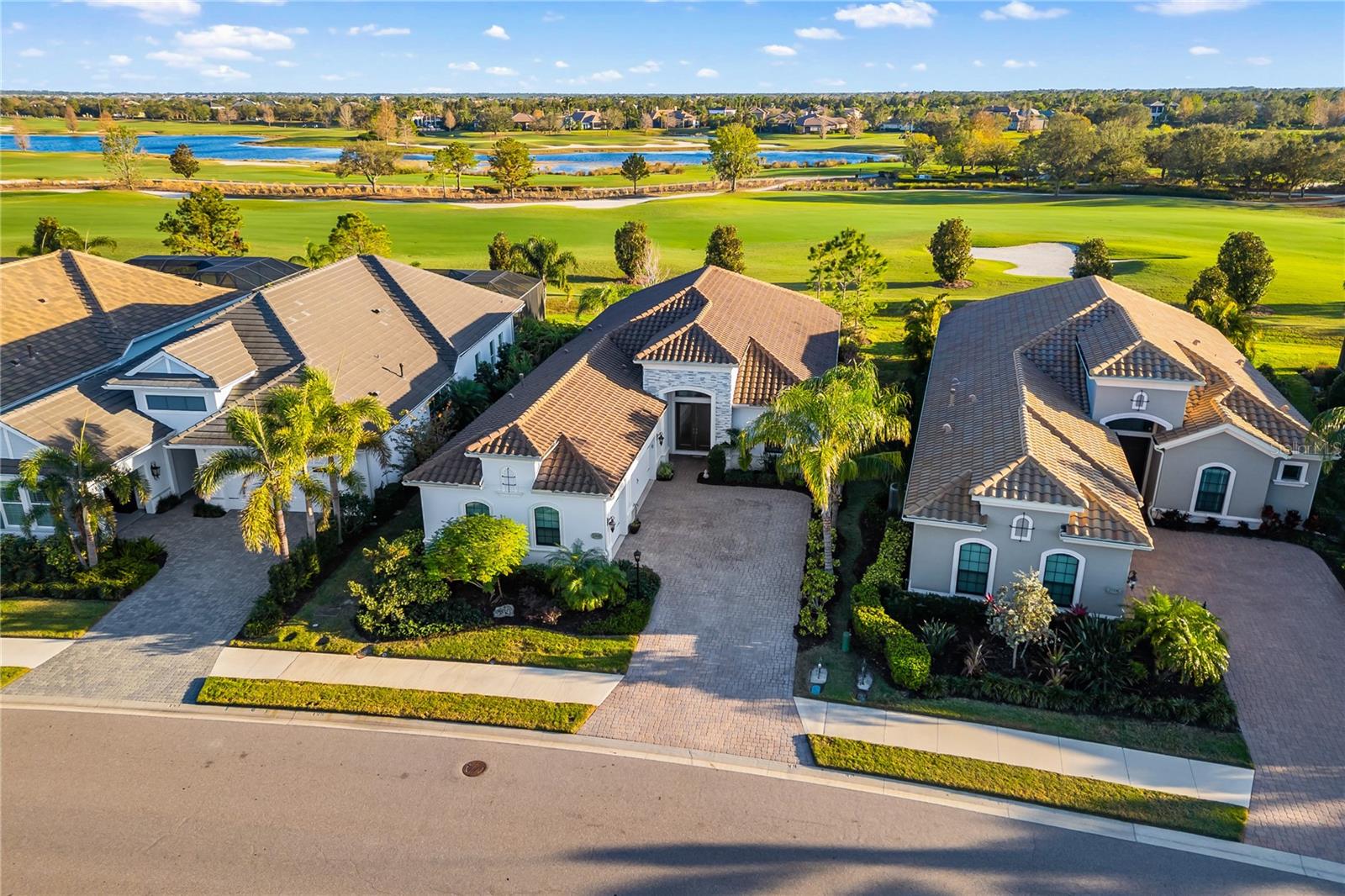 Welcome to 15520 Castle Park Terrace, a custom Neal Signature 3-bedroom, 2-bathroom home with breathtaking views of the golf course in the gated community of Country Club East. As you step inside, you'll be captivated by the meticulously designed interior, where natural light floods the open-concept living space. High-end finishes, custom tray ceilings, squared columns, 5 1/4" colonial baseboards, and crown molding add a touch of sophistication throughout. A striking aquarium window sets this home apart, offering picturesque views and a seamless connection to the outdoors. A seamless flow between the living room and kitchen creates the perfect atmosphere for both relaxation and entertaining. The luxury upscale kitchen features quartz counters, stainless appliances, large island with cabinets underneath over looking the living room, counter lights under cabinets, custom backsplash, and upgraded kitchen cabinets. The large formal dining room a perfect blend of sophistication and warmth, designed for both intimate dinners and hosting a holiday feast. The primary suite is a private retreat, offering spa-like elegance with a luxurious en-suite bathroom, double vanities, a custom tile walk-in shower, and two walk-in closets. Two additional bedrooms provide comfort and privacy for guests or family members, while a well-appointed second bathroom boasts a stylish tile tub/shower combination, a single-sink vanity, and modern fixtures. A versatile bonus room offers the flexibility to be a fourth bedroom, home office, or second living area. Step outside through panoramic sliding glass doors to your screened lanai, where you can take in the serene golf course views. Whether you're enjoying your morning coffee or hosting a gathering, this outdoor space is designed for relaxation and entertainment. This home has a three car garage with shelving, recessed lighting throughout the home, upgraded tile throughout the main floor, upgraded carpet and padding throughout bedrooms and bonus room, landscape lighting on the front/side/back, extra outdoor outlets, and a hurricane rated front door. Country Club East residents enjoy a maintenance-free, resort-style lifestyle with exclusive access to an amenity center, resort-style pool, fitness facility, nature trails, and more. Optional memberships for Lakewood Ranch Golf and Country Club are also available, offering golf, fitness, and social memberships. Conveniently located near premier shopping, dining, major highways, A-rated schools, and Florida’s top beaches, this home offers the best of luxury and location. Don’t miss your opportunity to experience this exceptional home—schedule your private showing today!