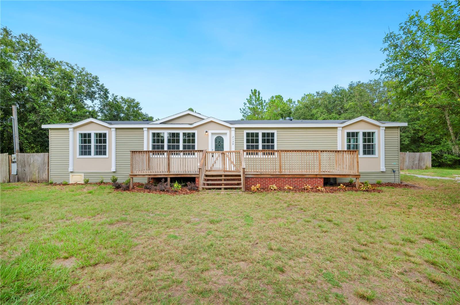 Welcome to your dream home nestled on a 1.6-acre corner lot in beautiful North Lakeland! Surrounded by mature trees offering exceptional privacy, this fully renovated 3-bedroom, 2-bath home blends modern upgrades with peaceful country charm.
Step inside to discover a brand-new spacious kitchen featuring sleek stainless-steel appliances, all-new cabinetry, and stylish countertops—perfect for cooking, entertaining, and everyday living. The home offers generously sized bedrooms, including a large primary suite with an updated bathroom boasting a soaking tub, double sink vanity, and ample storage. One of the secondary bedrooms includes a walk-in closet for added convenience.
Enjoy the comfort of new carpet and luxury vinyl plank flooring throughout the home. The layout offers both a spacious living room and a large family room or flex space, giving you plenty of room to relax, work, or entertain. A cozy dining area sits just off the kitchen, and an interior laundry room adds even more functionality.
Outside, the fenced-in backyard provides a safe and private space for pets, kids, or backyard BBQs. Relax on the large front deck and enjoy the peaceful surroundings. The home also features a brand-new roof and new A/C, giving you peace of mind for years to come!
If you’re looking for space, style, and a move-in ready home—all in a convenient North Lakeland location—this home checks every box. Schedule your showing today! USDA FINANCING AVAILABLE FOR ELIGIBLE BUYERS, WITH NO MONEY DOWN. CALL TODAY FOR MORE DETAILS.