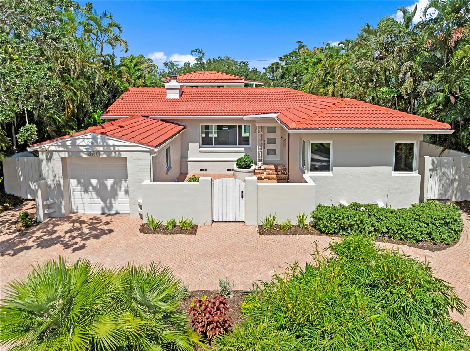 One or more photo(s) has been virtually staged. Historic Elegance Meets Modern Luxury on Snell Isle. Look at this rare architectural treasure in one of St. Petersburg’s most sought-after neighborhoods. Designed and built in 1938, this beautifully restored and thoughtfully updated Snell Isle estate blends timeless character with today’s modern comforts — offering privacy, luxury, and exceptional indoor-outdoor living. 4 Bedrooms and 4.5 Baths with Main Residence and Separate Guest House with Office. As you arrive, you're greeted by a circular driveway and charming entry courtyard. Inside the main house, vaulted beamed ceilings and a cozy gas fireplace create a warm and welcoming living space. The gourmet kitchen features quartz countertops, ceramic tile backsplash, gas stove, and ample cabinetry all flowing seamlessly into the dining room. A butler’s pantry, laundry room, and guest bath add functionality, while two bedrooms each offer en-suite baths with walk-in tiled showers. Step outside to a serene, private courtyard oasis — complete with a pool and spa, over 1,500 sq ft of hand-laid travertine pavers, and a covered 14x16 ft patio ideal for dining, entertaining, or relaxing. Surrounded by lush tropical landscaping and enclosed by a 6 ft block privacy wall, this space offers peaceful seclusion in the heart of Snell Isle. The separate guest house adds tremendous value and flexibility, with two additional bedrooms, each with its own en-suite bath and walk-in closet, plus a dedicated office or studio space with floor-to-ceiling windows overlooking the pool — perfect for working from home, a gym, or creative retreat. Just minutes from Downtown St. Pete’s waterfront parks, restaurants, marinas, shopping, and vibrant arts scene, this home offers an unmatched blend of historic charm, luxury living, and unbeatable location. Is this home your Perfect Match? Book your showing today!