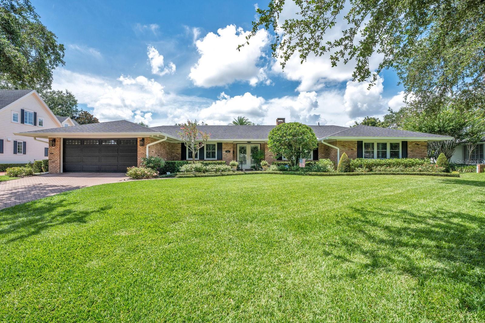 Welcome to this picturesque 3 bedroom, 4 bath pool home nestled in the highly sought-after neighborhood of Park Grove. Overflowing with charm and character, this naturally light-filled home features white oak hardwood floors and plantation shutters throughout. Upon entry, a formal living room with a cozy wood-burning fireplace greets you, offering serene views of the sparkling heated pool and lush backyard oasis. The elegant formal dining room leads to a chef's kitchen adorned with marble countertops, wood cabinetry, a spacious island with seating, and top-of-the-line appliances. A well-appointed wet bar adds to the home's entertainment appeal, while an informal dining space flows seamlessly into the expansive family room, where floor-to-ceiling windows invite the beauty of the outdoors in. Step outside to a covered porch and summer kitchen- perfect for hosting. Enjoy al fresco dining under the shade of a covered pergola or relax by the glistening pool in complete privacy. The home features two secondary bedrooms, each with its own en-suite bath, and a full guest bath off the hallway. The primary suite is a true retreat, offering a private sitting area, his-and-hers closets, and a luxurious bath with dual vanities and a large walk-in shower. Located just minutes from the vibrant shops and fine dining of Park Avenue in downtown Winter Park, and zoned for top-rated schools- this home is an exceptional opportunity you won't want to miss!