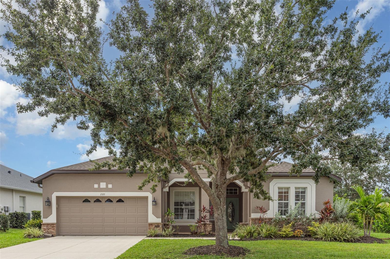 Welcome to River Plantation Living.
This beautifully appointed four-bedroom, two-bathroom residence offers nearly 2,200 square feet
of thoughtfully designed living space in the highly desirable River Plantation community.
Blending comfort, style, and functionality, this home is ideal for both everyday living and
effortless entertaining.
Step inside to an inviting open-concept floor plan that includes a formal living room and a
separate dining room, perfect for hosting gatherings. At the heart of the home, the kitchen shines
with Corian countertops, stainless steel appliances, abundant cabinetry, and a large island with
breakfast bar seating. An eat-in dining nook adds charm and convenience, while the kitchen’s
seamless connection to the family room creates a bright and spacious setting for daily living.
The private primary suite is a true retreat, featuring two walk-in closets and a spa-inspired
bathroom with dual vanities, a relaxing garden tub, and a separate glass-enclosed shower. Three
additional bedrooms are tucked toward the rear of the home, sharing a well-appointed guest bath,
offering comfort and privacy for family and visitors alike.
Elegant hardwood flooring flows through the main living areas, while brand-new carpeting
enhances each bedroom. High ceilings throughout add to the home’s open, airy feel. Step outside
to the covered lanai and enjoy Florida’s year-round lifestyle, whether sipping morning coffee or
entertaining friends in the shade.
Set on a spacious corner lot with fresh landscaping and enhanced by a beautiful stone elevation,
this home exudes curb appeal from the moment you arrive.
Experience all that River Plantation has to offer—schedule your private showing today and
discover the perfect place to call home.