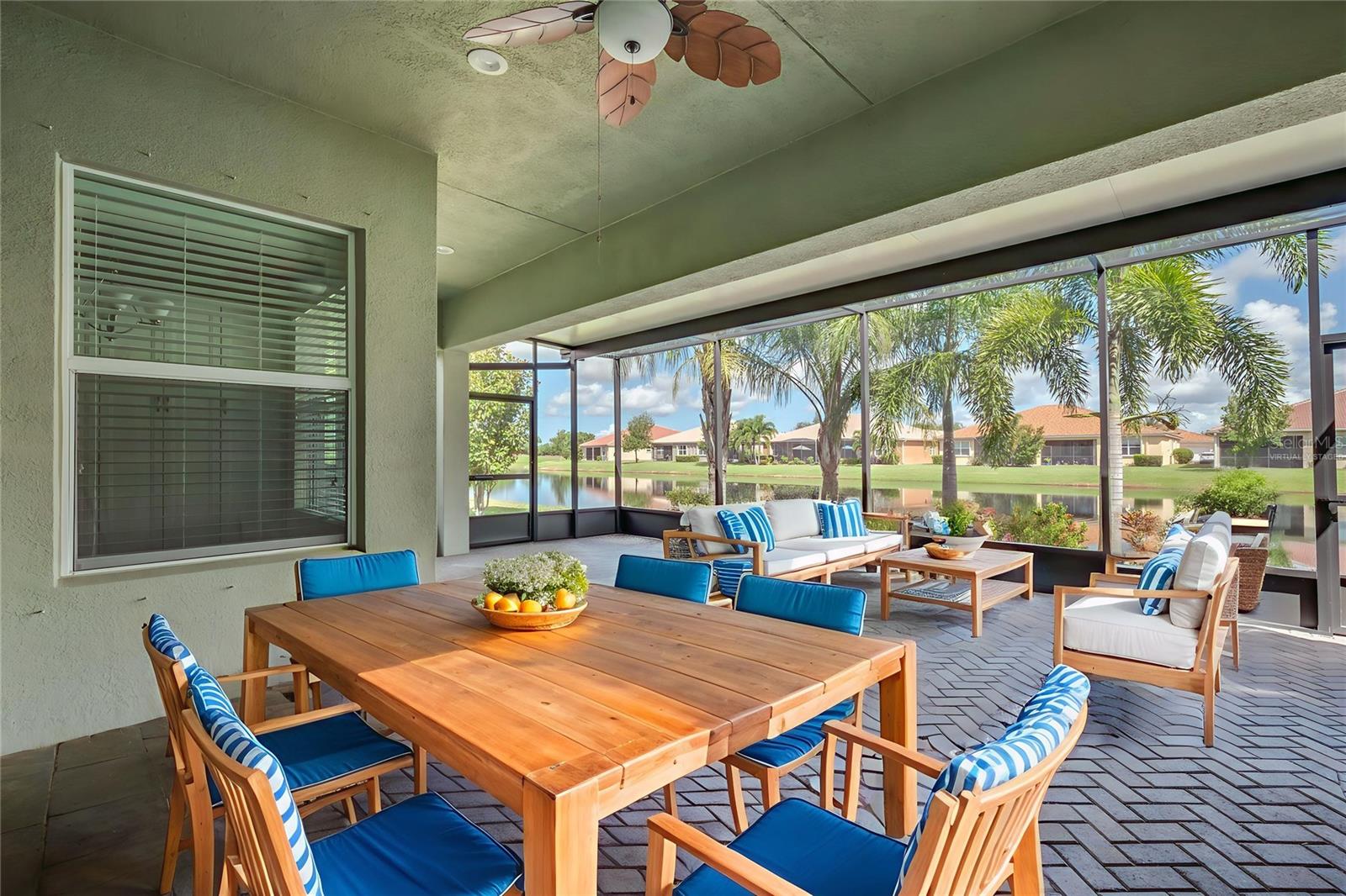One or more photo(s) has been virtually staged. Welcome to luxury living at its finest in this exquisite Palazzo model by GL Homes, nestled in Valencia Lakes, Tampa Bay's premier 55+ resort-style community. This immaculate home offers a spectacular waterfront setting, enjoyed best from the extended screened lanai—a tranquil space perfect for morning coffee or evening sunsets. From the moment you arrive, the brick paver driveway and walkway, barrel tile roof, and lush landscaping with lighting create stunning curb appeal and a warm welcome home. Step through the double 8-foot entry doors into a grand foyer with 11-foot coffered ceilings and crown molding, setting the tone for the refined style throughout. With 3 spacious bedrooms, a large den that can serve as a fourth bedroom, 2.5 bathrooms, and a 2.5 car garage, this home provides both luxury and functionality. The open concept floorplan includes a great room with a coffered ceiling and striking 12x24 porcelain tile laid in a waterfall pattern, seamlessly connecting to the gourmet kitchen, casual dining area, and formal dining space. The chef's kitchen is a true showstopper, featuring quartz countertops, undermount stainless steel sink, 42” soft-close white maple cabinetry, designer glass backsplash, under and over-cabinet lighting, and premium stainless steel appliances. There’s also a triple cabinet pantry with roll-out shelves, pull-out trash system, and cabinet paneling package for a clean, custom look. For more formal gatherings, the dedicated dining room is conveniently located just off the kitchen. Retreat to the luxurious primary suite, complete with coffered ceiling, two large walk-in closets, tile flooring, and a sitting bay window overlooking the private water view. The primary bath is equally impressive, offering dual vanities, quartz countertops, shaker-style cabinets, and a walk-in shower with a built-in seat and tile to the ceiling. Guest bedrooms are privately situated on the opposite side of the home for optimal privacy. The oversized den with double 8-foot entry doors and tile flooring offers versatility as a home office, media room, or extra guest space. The second full bathroom features quartz counters with a banjo top, upgraded white cabinetry, and a tiled tub/shower combo. A conveniently located powder room includes a built-in linen closet, white cabinets and quartz counters. The laundry room features white cabinetry, a utility sink, and upgraded washer and dryer with direct access to the over-sized garage. This home comes with many upgrades, including designer lighting and ceiling fans, whole house water softener and filtration system, epoxy garage flooring, overhead garage storage racks, extended screened lanai with paver extension, gutters, additional landscaping and more. Beyond your doorstep lies the unmatched lifestyle of Valencia Lakes—a gated, vibrant community with a 40,000 sq. ft. clubhouse, 24-hour fitness center, resort-style pools, on-site bistro, pickleball and tennis courts, bocce ball, walking trails, clubs, live entertainment, arts and crafts, cooking classes, and so much more. Don't miss your chance to own this exceptional home in one of the most sought-after active adult communities in the Greater Tampa Bay area. Schedule your private showing today and start living your best life at Valencia Lakes.