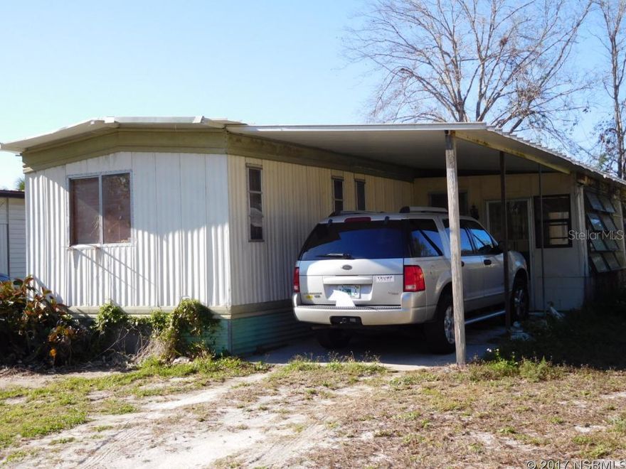 Affordable waterfront living! It is all about the location here - park your boat at your own dock and you're just a short ride up the canal to the best fishing & shrimping around... or just watch the manatees from your seawall. This 3 bedroom 2 bath mobile home will be great for full time, weekend or seasonal living. Inside you will find an open kitchen, dining & living area and split bedrooms. It has a large open porch on one side, an enclosed porch on the other side and a covered carport for parking. No HOA, no fees & no rules here. A few updates and a little TLC will go a long way. Owner Financing available too! ;Water: City