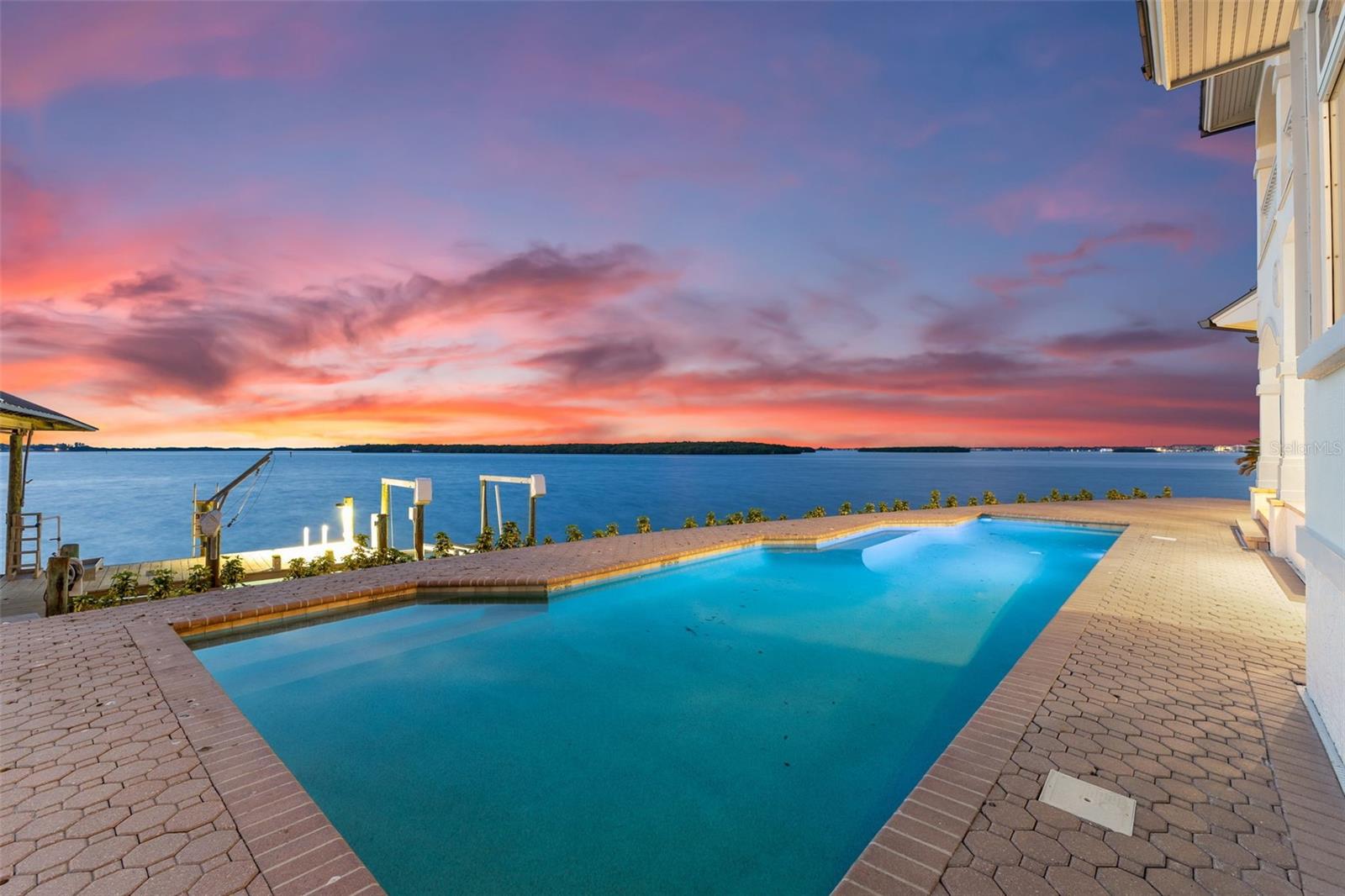 One or more photo(s) has been virtually staged. Ideally situated on a prime lot that boasts unobstructed panoramic water views. This extraordinary estate offers a secluded cul-de-sac location and an expansive 166 feet of BRAND NEW SEAWALL, providing unmatched privacy and a vast sense of space.
Originally built in 1995, this newly available estate, crafted by the acclaimed 'Monogram' builders, stands as a testament to luxury and meticulous design. The residence includes six spacious bedrooms, four and a half lavish bathrooms, and an oversized two-car garage. Recently enhanced with a brand NEW METAL ROOF, NEW WOOD FLOORING throughout, and a fresh modern color scheme, the home exudes coastal elegance and timeless charm.
Your private backyard retreat offers breathtaking views of St. Joseph Sound, the prestigious Carlouel Yacht Club, and Moonshine Island. The private dock is a boater’s dream, complete with a covered 15,000 lb BOAT LIFT, a 6,000 lb BOAT LIFT, a DEEP-WATER SLIP, and a deck area fully equipped with water and electrical hookups.
Outdoor living is perfected with a covered lanai and a private, heated Pebble Tec swimming pool, ideal for both relaxation and entertainment. As you step inside, you are immediately captivated by the expansive water views that greet you and extend through the family and living rooms, enhancing the home’s serene ambiance.
The luxurious primary suite features 10-foot ceilings and a private balcony that offers stunning vistas and a tranquil escape. The primary bathroom is a spa-like haven with a steam shower, a garden tub, and a spacious walk-in closet designed for ample storage.
Island Estates, nestled along the Gulf Coast, provides a serene and luxurious lifestyle with a variety of amenities including charming shops, convenient banks, vibrant bars, and exquisite restaurants. This community offers a unique blend of tranquility and vibrancy, allowing residents to enjoy the best of both worlds.
Just a short bike ride or walk away, Clearwater Beach is consistently ranked as the top beach in the United States. Known for its soft, white sand and crystal-clear waters, Clearwater Beach is perfect for sunbathing, swimming, and a variety of water sports. The area is also home to Pier 60, where you can enjoy nightly sunset celebrations, live entertainment, and local artisans.
Whether you seek relaxation under the sun or thrilling water activities, Island Estates and Clearwater Beach offer an irresistible blend of luxury and leisure. This stunning waterfront estate is not just a home; it's a lifestyle, providing you with the perfect sanctuary to enjoy the best that Florida's Gulf Coast has to offer.