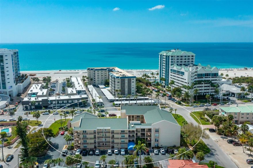 BEACH LOVERS WANTED!  You can experience the Lido Key lifestyle daily in this updated 1-bedroom + den 3rd floor Condo with pool and peakaboo Sarasota Bay views. Ideally located directly across from Lido Beach and a short walk to St. Armand Circle, Ted Sperling Park,  and Lido Beach Park.  Perfect for easy beach-to-door living!!  With only 40 Units, this Boutique Community is your perfect hideaway.  The property abounds with palm trees and exotic plants.  There is elevator access or two sets of stairs. Recent Condo updates include custom reclaimed wood kitchen & bathroom cabinetry (from the Brooklyn Shipyard), newer appliances-stone tiled bathroom- air conditioning-hot water heater-and impact sliding doors. Being offered completely furnished (*except some artwork, antiques)- just bring your suitcases! The Bayrunner Trolley stops out front and is free. Enjoy Sarasota's extensive Arts, Restaurants and nightlife without ever worrying about parking after your day in the sun.  Make an appointment to see this gem now.