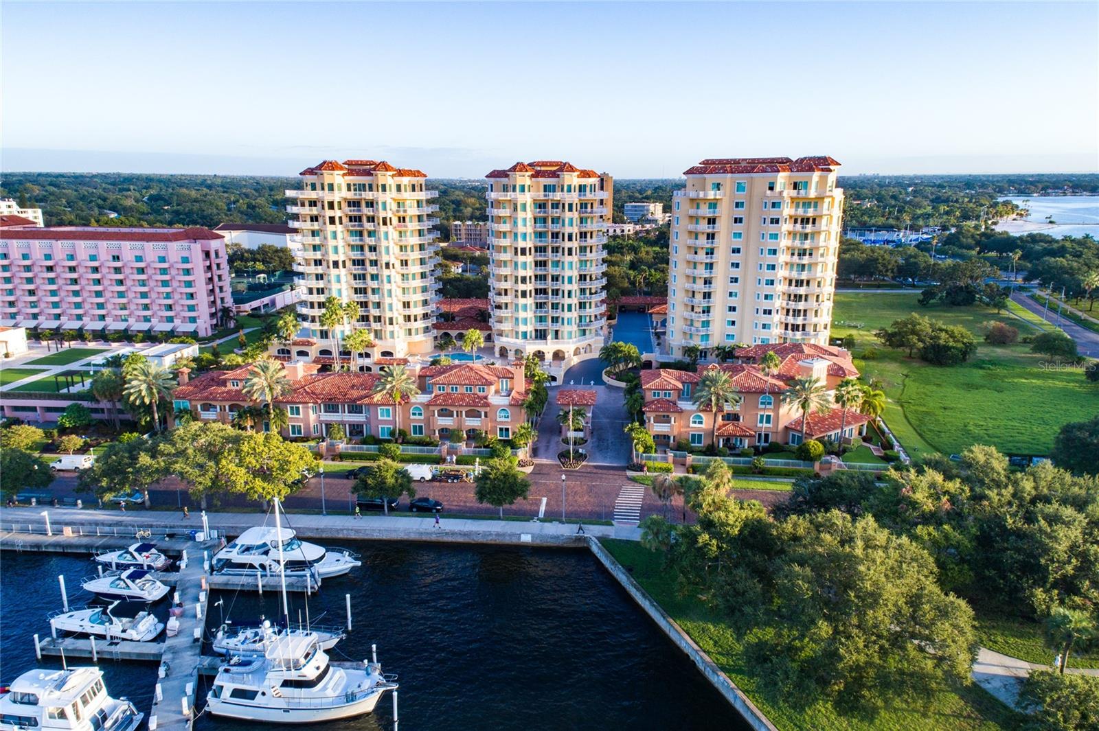 Available November 1st! Experience breathtaking sunrises and stunning views of the St. Petersburg Pier, Tampa Bay, the downtown St. Petersburg skyline, and the marina basin from three private terraces and every room in this expansive 3,000-square-foot, 10th-floor condo with exclusive elevator access. This open-concept residence features three bedrooms, two and a half baths, and luxurious custom finishes throughout, all thoughtfully updated in August 2020. The beautifully renovated kitchen boasts wood cabinetry, a massive island with a concrete farmhouse sink, granite countertops, bar seating, a Sub-Zero refrigerator with matching cabinet panels, a wine refrigerator, and an induction range. The light-filled living room showcases panoramic water views and a stylish designer fireplace, perfect for entertaining. A large den or office space, complete with tray ceilings and recessed lighting, provides an ideal home workspace or additional living area. The master suite is a true retreat, offering built-in modern cabinetry, captivating views, a spacious walk-in closet, and sleek contemporary lighting. The en suite bathroom is a spa-like sanctuary, featuring granite countertops, elegant cabinetry, a glass-enclosed shower with a rain head and wand, and a large heated soaking tub. Two additional generously sized bedrooms, connected by a fully updated Jack-and-Jill bathroom, provide comfort and privacy for family or guests. Every detail in this one-of-a-kind residence has been meticulously curated, from the hardwood floors and crown molding to the custom built-ins throughout. Residents enjoy premium amenities, including two assigned covered parking spaces, heated pools, a fitness center, concierge services, and community spaces. Just under a mile from world-class dining, shopping, and museums, don't miss the chance to call The Vinoy home!