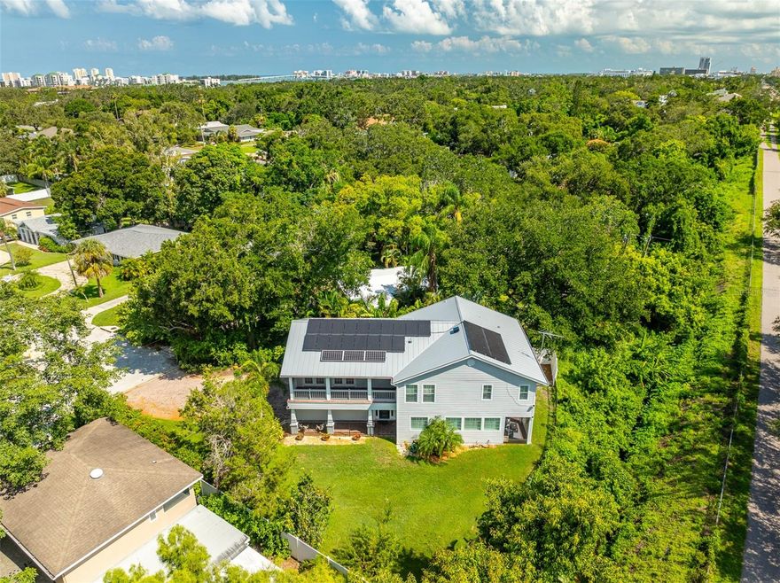 Savings abound in this green energy-efficient single-family home at the quiet end of a Belleair cul-de-sac, where privacy meets nature, an exceptional residence rises above expectation — a 3,072-square-foot expression of modern comfort, intelligent design, and timeless Florida living. From its gleaming metal roof (2024) to its 31-panel solar array with battery backup, this home embodies the art of living beautifully and sustainably. Framed by mature greenery and the Pinellas Trail just beyond the backyard, the setting is both secluded and connected — a rare duality. Every upgrade tells a story of foresight: Hardie board exterior for low maintenance, natural gas connections for performance, generator hook-up for peace of mind, and a Rinnai tankless water heater (2024) for efficiency.
SOLAR PANELS CAN SIGNIFICANTLY REDUCE ELECTRICITY BILLS, METAL ROOFS IMPROVE INSULATION AND DURABILITY, LED LIGHTS LOWER ENERGY CONSUMPTION AND TANKLESS WATER HEATERS CUT DOWN ON ENERGY USE BY HEATING WATER ON DEMAND. ALL IN ALL, THEY ADD UP TO SOME PRETTY SUBSTANTIAL SAVINGS YEAR AFTER YEAR!
Inside, natural light moves effortlessly through high ceilings and refined details — plantation shutters, crown molding, and a timeless palette that complements any style. The main level flows from a refined living and dining area to a screened patio, perfect for slow mornings or sunset conversations. The culinary kitchen is designed for those who love to cook and gather — featuring stainless steel appliances, a KitchenAid dishwasher (2025), microwave/convection oven, and gas range framed by double sinks and smart storage. A nearby laundry and butler’s pantry adds ease and elegance to daily living. Upstairs, the primary suite is a private sanctuary with dual walk-in closets and a serene bath boasting granite countertops, dual Kohler sinks, walk-in shower, and a soaking tub. Two additional bedrooms and a spacious bonus room — ideal for a media lounge, home office, gym, or fourth bedroom — provide versatility for modern lifestyles.
Outdoor living unfolds across two screened-in patios, each designed to capture soft breezes and southern light. The fully fenced backyard features lush landscaping, mango trees, and ample room for a custom pool, inviting endless opportunities to personalize your oasis. An oversized two-car garage with abundant storage completes the home’s thoughtful design, offering functionality without compromising on aesthetics. With dual A/C systems (2018), upgraded irrigation well and pump (2024), added attic insulation, and motion-sensitive LED lighting, every feature has been considered for longevity, comfort, and effortless living. This is Belleair living for the discerning — where sustainability meets sophistication, and every detail works in harmony with the way you live today. CALL TODAY FOR A SHOWING!