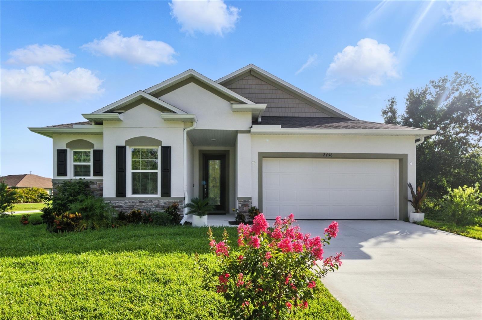 Like-New 3-Bedroom Home with Designer Upgrades and Fenced Yard! This beautifully appointed 3-bedroom, 2-bathroom home offers 1,845 square feet of stylish living space in a quiet North Port neighborhood. The thoughtfully designed open-concept layout features a spacious great room, oversized 11.5-foot island, and generous dining area—perfect for entertaining or everyday comfort. Enjoy top-tier upgrades throughout, including quartz countertops in the kitchen and baths, soft-close cabinetry, brushed nickel fixtures, and ceramic tile flooring in the main living areas. All bedrooms are carpeted for comfort. The primary suite boasts a tray ceiling, comfort-height toilet, and a large walk-in closet. Crown molding and 5 ¼” baseboards throughout the main living area add a touch of elegance. Outside, find a serene screened lanai, fully fenced backyard with black aluminum fencing, and lush St. Augustine grass maintained by an underground irrigation system. Exterior enhancements include stone accents, window shutters, upgraded landscaping, gutters, and a garage door opener with remotes. Additional highlights include 9’4” ceilings, cordless window blinds, reverse osmosis water filtration under the kitchen sink, and a premium water treatment system. This home is move-in ready and loaded with high-end finishes—schedule your showing today!