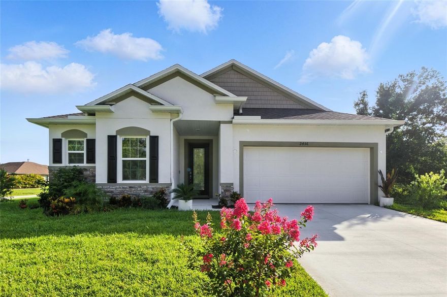 Like-New 3-Bedroom Home with Designer Upgrades and Fenced Yard! This beautifully appointed 3-bedroom, 2-bathroom home offers 1,845 square feet of stylish living space in a quiet North Port neighborhood. The thoughtfully designed open-concept layout features a spacious great room, oversized 11.5-foot island, and generous dining area—perfect for entertaining or everyday comfort. Enjoy top-tier upgrades throughout, including quartz countertops in the kitchen and baths, soft-close cabinetry, brushed nickel fixtures, and ceramic tile flooring in the main living areas. All bedrooms are carpeted for comfort. The primary suite boasts a tray ceiling, comfort-height toilet, and a large walk-in closet. Crown molding and 5 ¼” baseboards throughout the main living area add a touch of elegance. Outside, find a serene screened lanai, fully fenced backyard with black aluminum fencing, and lush St. Augustine grass maintained by an underground irrigation system. Exterior enhancements include stone accents, window shutters, upgraded landscaping, gutters, and a garage door opener with remotes. Additional highlights include 9’4” ceilings, cordless window blinds, reverse osmosis water filtration under the kitchen sink, and a premium water treatment system. This home is move-in ready and loaded with high-end finishes—schedule your showing today!