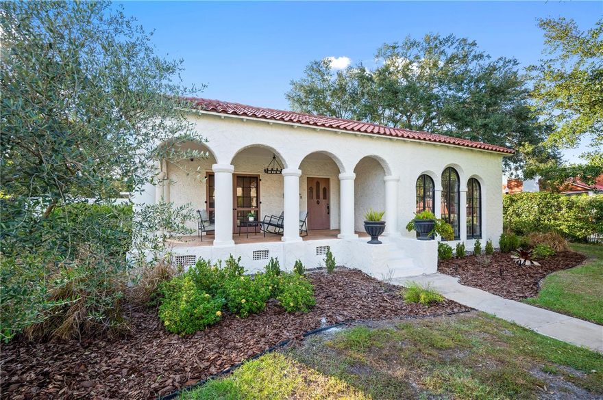 Welcome to this iconic 1925 Spanish Colonial in the coveted Biltmore-Cumberland Historic District of Lake Hollingsworth. Dressed in stucco, columns, and graceful arches, this residence stands as an anchor of neighborhood history and architectural character. Known as the Ludd M. Spivey House, this property once belonged to the Florida Southern College president who invited Frank Lloyd Wright to redesign the campus. It’s said that Wright himself visited this home, meeting in the arched, sunken living room that still radiates timeless charm.
The main home offers 4 bedrooms and 2 full bathrooms across 2,842 sq. ft., blending historic warmth with modern comfort. A moody hallway illuminated by gold globe lighting leads to the bedrooms, including a Jack-and-Jill suite and a spacious primary just across from a full bath. A flex room or office with French doors and a wood-burning fireplace anchors the front of the home and opens onto a welcoming front porch. At the heart of the home lies a 2021 remodeled kitchen, surrounded by natural light and backsplash tile reaching to the ceiling. Outfitted with Thermador appliances, including a 36” gas range, convection microwave, and designer hood vent, this kitchen boasts quartz waterfall countertops and a generous island with bar seating. Engineered hardwood floors flow throughout, creating a seamless and cohesive design. Outdoors, a resurfaced pool with tanning shelf, Spanish-style tile, and lush new landscaping form an inviting private oasis. The 555 sq. ft. guest apartment includes a 1-bedroom layout with a living room, kitchen, and full bath — ideal for guests or rental income. Situated on nearly half an acre, this historic home comes with a new roof installed prior to closing, ensuring both preservation and peace of mind. Enjoy proximity to Lake Hollingsworth, Florida Southern College, local eateries like The Peach House, and Black & Brew, making this residence a perfect blend of history, style, and location.