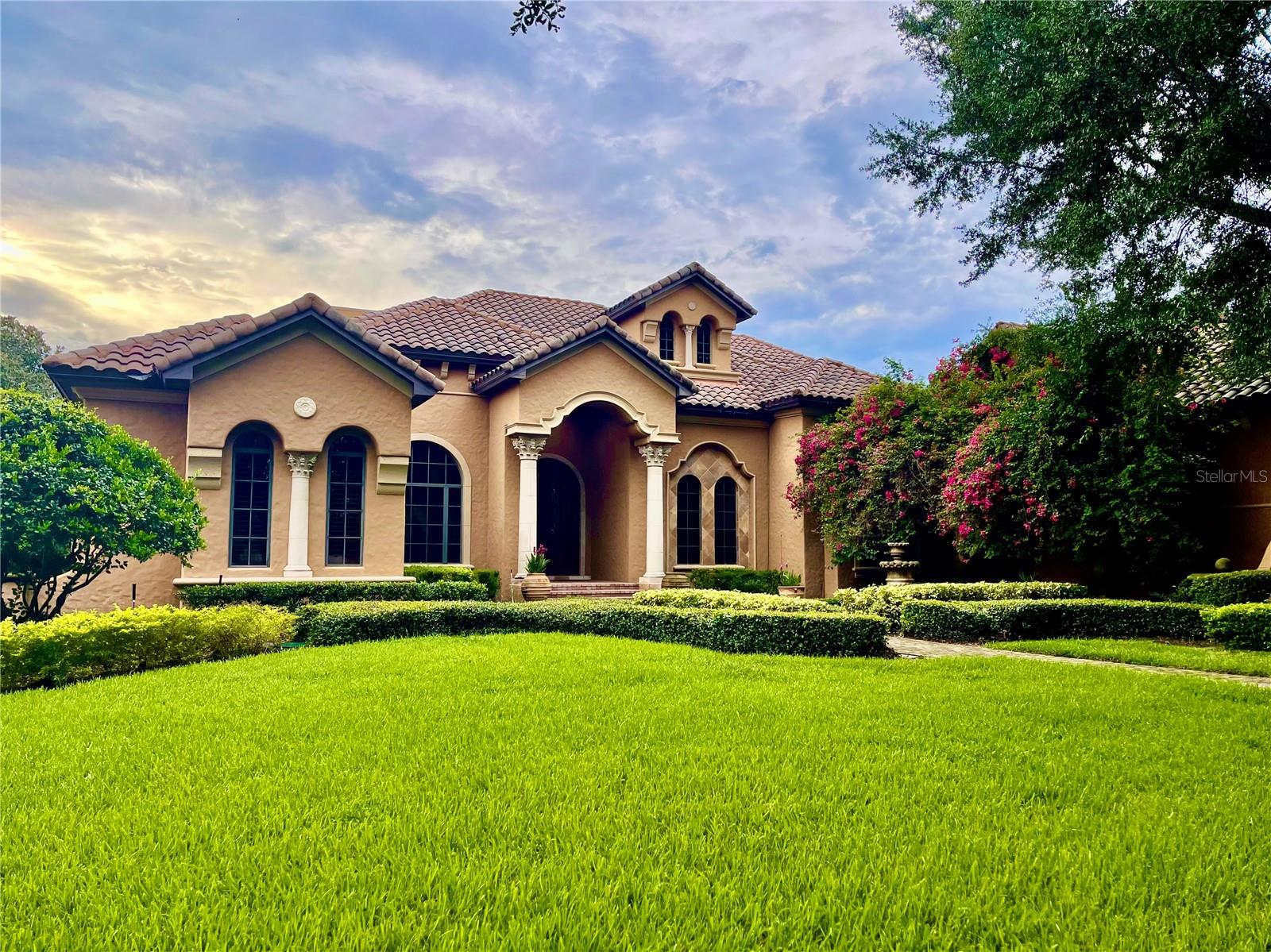 Custom-Built Golf Estate in Keene's Pointe, one of Windermere's most sought-after communities. This home greets you with lush landscaping, paver walkways, and a custom-built wood and iron double front door. Featuring a formal living and dining room with wet bar and wine cellar, private office, and primary suite with a spacious bath including dual sinks, rain shower and custom lighting and access to the large walk-in closet. The private executive office has beautifully crafted woodworking in the ceiling and walls and custom built-in desk and library. All secondary bedrooms feature walk-in closets and their own en-suite bathroom. The kitchen offers a commercial grade range, double dishwasher, trash compactor and walk-in pantry, all of this opens up to the breakfast nook, family room and overlooks the oversized lanai, pool/spa and golf course. The game room features a full-service bar with refreshment cooler and Ice Maker. The oversized patio boasts plenty of covered area to create your own oasis and is complete with its own gas fireplace and full summer kitchen. A spacious laundry and 3-car garage complete this home.