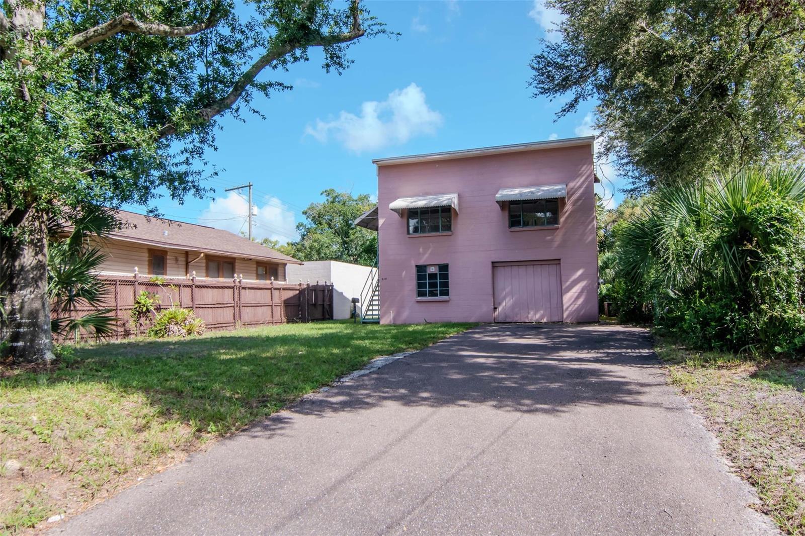 Investor Special! This perfectly located two-level block home is ready for the right investor with vision. The upstairs features fresh paint, hardwood flooring, two bedrooms, one bath, living room, and kitchen. The space has been partially rehabbed, with cabinets and appliances removed and awaiting the next owner’s custom design. Downstairs is where the true potential lies—729 sq. ft. currently configured as a garage and former film development room. With plumbing and electric already in place, the area can be reimagined as a spacious studio with kitchen and bath, or even converted into additional bedrooms. The property also offers a massive asphalt driveway that easily accommodates four or more vehicles, with room to expand into a half-circle drive if desired. Solid block construction provides durability and peace of mind. This home definitely needs TLC, but for the right buyer, it’s a rare opportunity to create something special in a prime location.