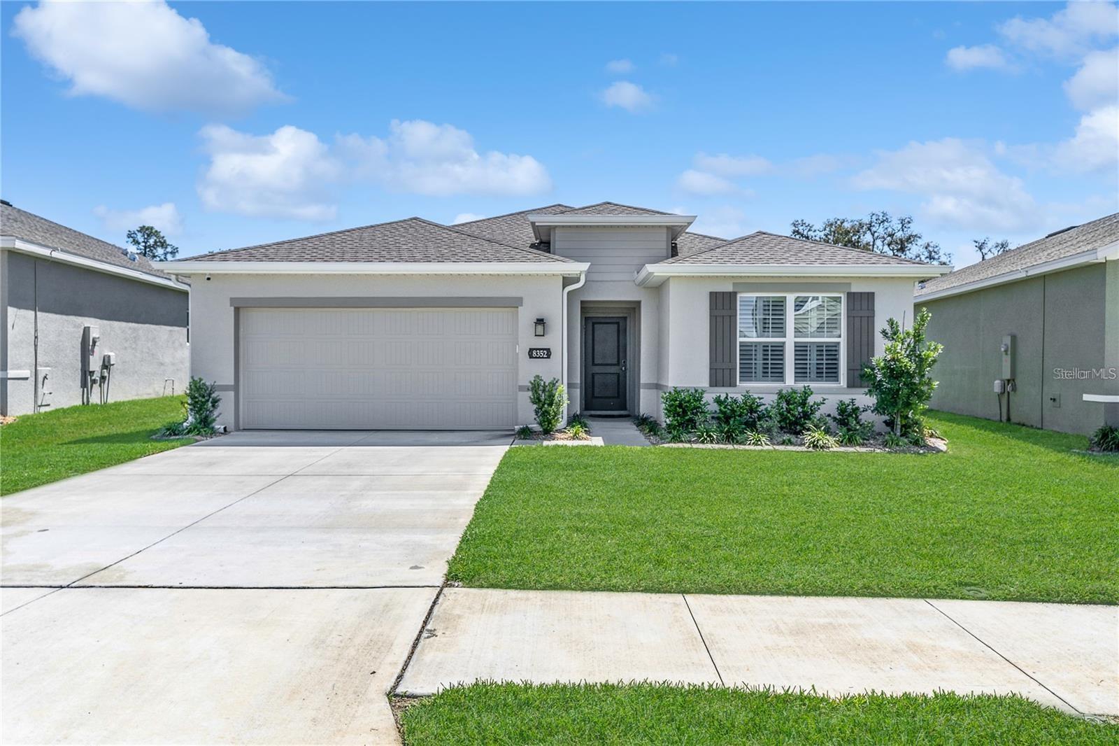 An inspiring home, in the ever-popular residential community of Park Meadows. This well-maintained home has what everyone is looking for, offering three bedrooms, two baths, a two-car garage and a lanai with a serene pond view and no rear neighbor. There’s a lot to love about this home, a 2023 built open concept home, with soft decorator and added features, such as plantation shutters, stylish ceramic tile floors, and oversize baseboards. Then the joy to everyone is the beautiful gourmet kitchen, featuring the hard surface countertops with a deep stainless sink, stainless appliances, glass top range and beautiful white, soft close Shaker cabinetry and a large pantry. The large center island provides a breakfast bar and will be the gathering place when you are entertaining your guest. You will enjoy the back lanai with the peaceful pond view, while you're grilling out and watching your family play, relax and entertain. The primary retreat also shares the serenity pond view. Its bath features a large walk-in shower, his and her separate vanities with hard surface countertops, and an oversize walk-in closet that includes a custom closet system. This home is a two-way split plan, giving privacy to the main suite on the opposite side of the home, you will find two bedrooms and a bath on the other side. This home is great for entertaining family and friends, enjoying great weekends, spending the day at the community pool with two covered cabanas, or spending your day at the Wesley Chapel District Park, with lots of great activities. Park Meadows is ideally situated just across the street from Cypress Creek Middle School, Cypress Creek High School (A-rated), and Pasco-Hernando State College. You’ll be able to enjoy the top shopping or dining out at the Krate at the Grove, Tampa Premium Outlets, and The Shops at Wiregrass. A new Target store at The Grove is set to open soon, adding even more convenience to this growing area. Conveniently located just off the new Overpass exit near I-75 and close to the Lagoon community.