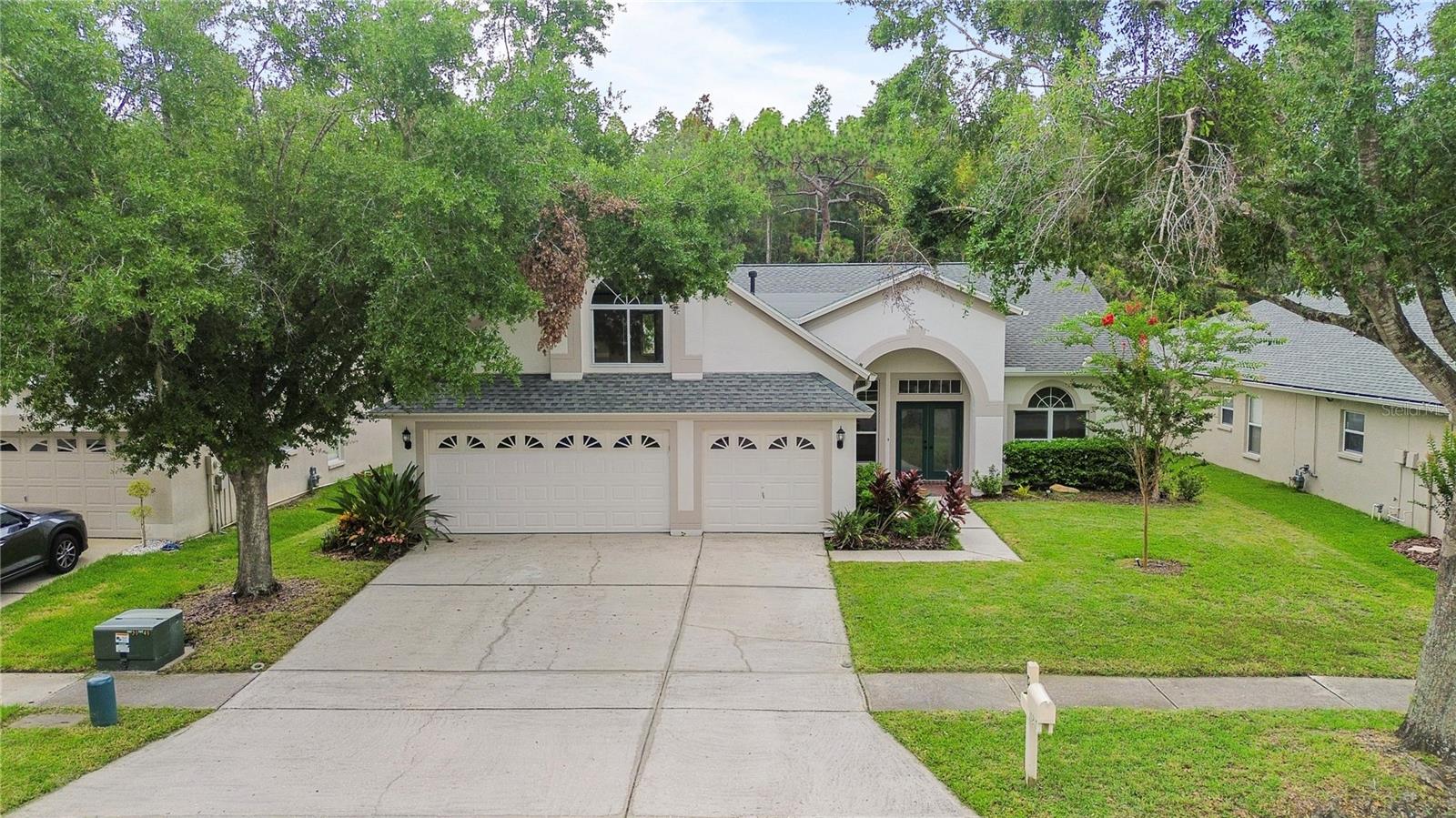 Fully remodeled and move-in ready, this spacious 4-bedroom, 3-bathroom home offers a 3-car garage and a large upstairs additional room. The open floor plan features extra-high ceilings and a triple-split layout, perfect for modern living. The home backs up to conservation, providing privacy with no rear neighbors. The Arbor Greene community has a clubhouse with a pool, tennis courts, pickleball, and more. It's ideally located near top-rated schools, grocery stores, restaurants, and Wiregrass Mall. With easy access to major roads, hospitals, and parks, just 20 minutes from Busch Gardens, 30 minutes to Tampa International Airport, and an hour to Disney. Don't wait, this won't be on the market long!