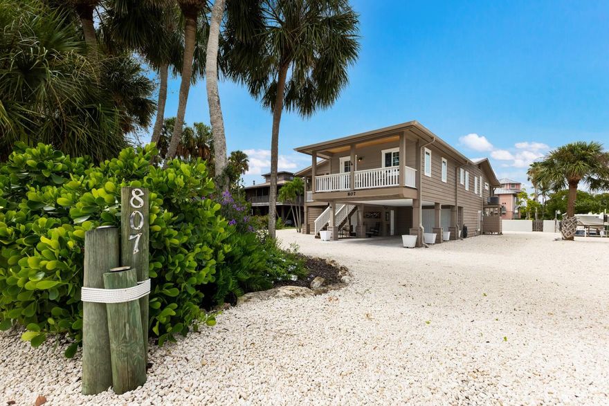 Experience the perfect blend of modern luxury and coastal functionality in this impeccably maintained canal-front retreat. Located on the prestigious North End of Anna Maria Island, this property offers the best of both worlds: a serene, full-time sanctuary or a high-performing investment (7 nights or less).  Originally transformed by a total remodel and significant additions in 2016, this elevated 3-bedroom, 2-bathroom residence offers a sophisticated island lifestyle on an expansive, oversized lot of over 10,000 square feet. The home is thoughtfully designed for both comfort and accessibility, featuring a private elevator that services the residence with ease.  The interior transitions seamlessly from open-concept living areas to a unique ground-level bonus room. This versatile space is fully climate-controlled with its own bathroom, making it an ideal candidate for a private guest suite, a secluded home office, or a premier media/game room. Outside, the property is a true maritime sanctuary. Boaters will appreciate the 10,000 lb boat lift and the peace of mind provided by a new seawall installed in 2021.  The outdoor possibilities are as vast as the lot itself; with ample room to install a custom pool and outdoor kitchen, you can create the ultimate backyard oasis. Whether you are enjoying the breeze from the elevated decks or embarking on a sunset cruise from your backyard, 807 S Bay Blvd represents a rare opportunity to own a waterfront home built for the modern Floridian lifestyle - a true boater’s sanctuary!