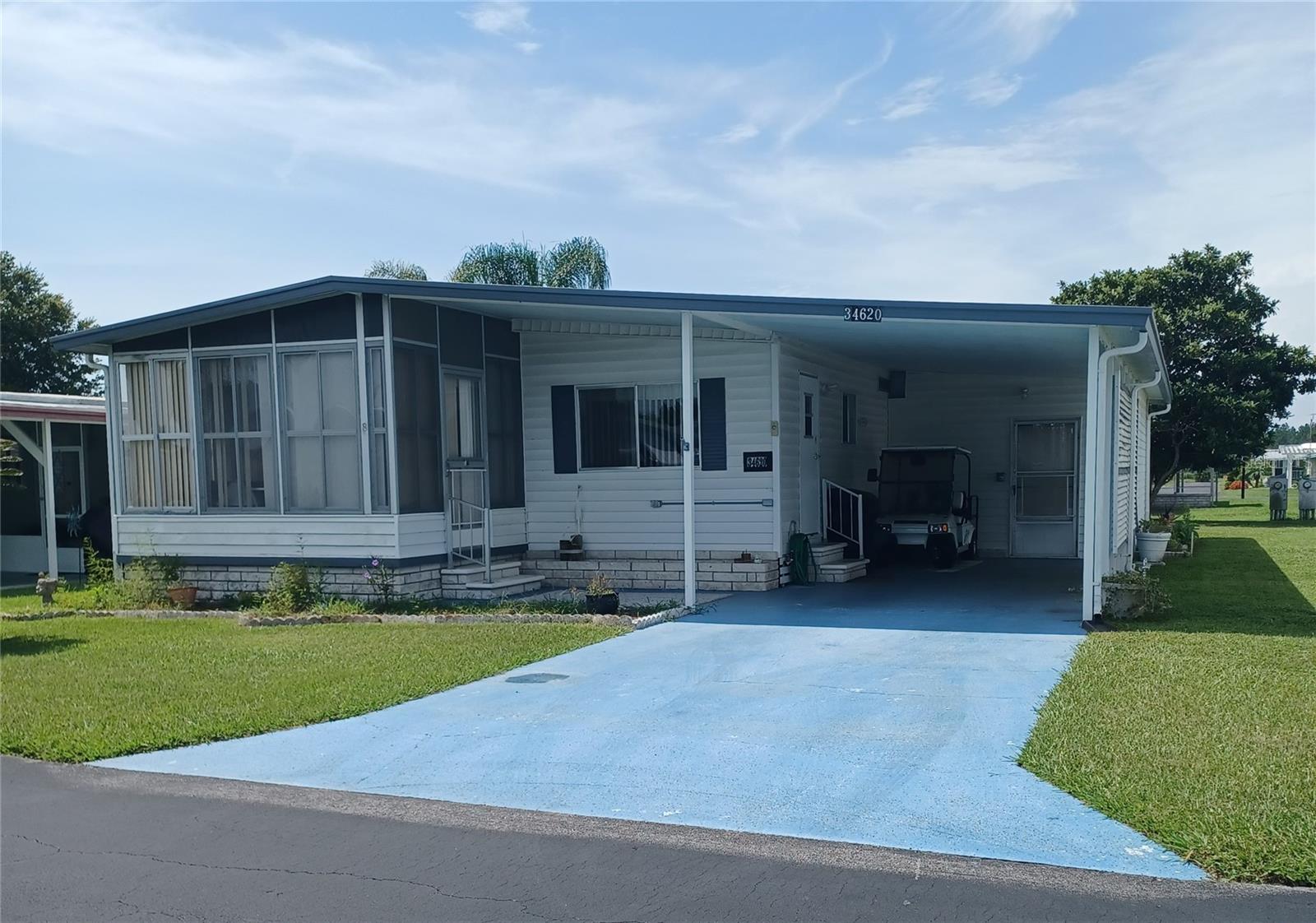 NO LOT RENT HERE!. Own the land. The low $80.00 per month HOA fee allows use of the heated pool, shuffleboard courts and use of a clubhouse where you can enjoy community get togethers. The monthly fee also includes water, sewer and trash pickup. This 2-bedroom, 1.5 baths doublewide comes furnished. As you enter the home you have an open kitchen dining area with plenty of cabinet space and dining area. The 17'11' living room has an entrance to the enclosed porch where you can sit and relax and watch the bikers, walkers and golf cart riders circling the neighborhood. The hallway leads to the 2 bedrooms one of which has a 1/2 bath and a full bath in the hallway. Both bedrooms have large walk-in closets. The Seller wants Buyers to be aware of soft areas in the floor.