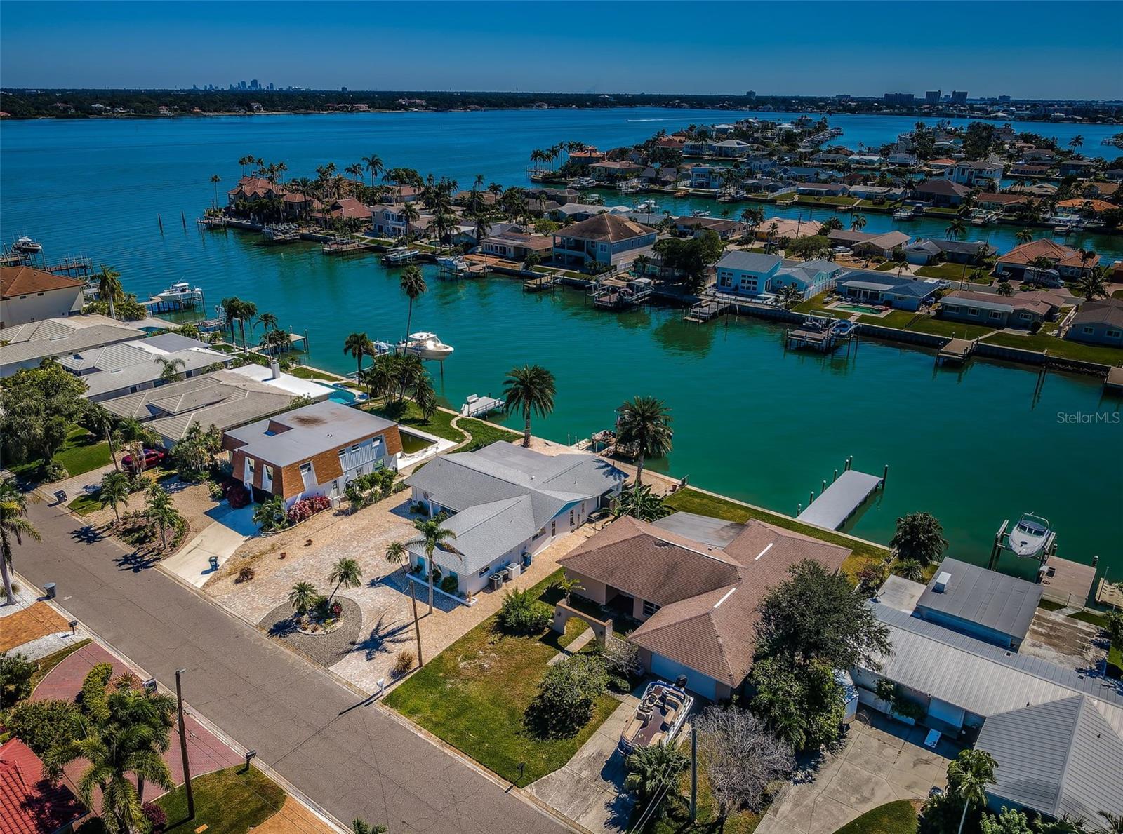 Remediated and ready for your restoration project.  Located on beautiful water in the wonderful upscale boating community of Capri Isle, this split bedroom plan, 3 bedroom, 2 bath home is within enjoyable walking distance of Treasure Island’s pristine white sand beaches, and its exceptional dining and entertainment.  This residence offers a full 70ft of water frontage, a sizable 2-car garage, indoor laundry, a 200sqft screen-enclosed waterfront lanai, and a large updated composite dock with step-down area for kayak/paddleboard launch.  From here, you’re just a 5-minute boat ride to the Gulf!  This is an outstanding opportunity to build equity in a waterfront home located in one of Tampa Bay’s premier waterfront/boating communities.  Dimensions are estimates, buyer to verify.