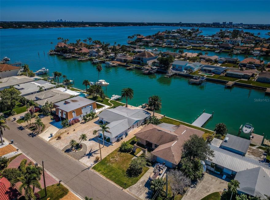 Remediated and ready for your restoration project.  Located on beautiful water in the wonderful upscale boating community of Capri Isle, this split bedroom plan, 3 bedroom, 2 bath home is within enjoyable walking distance of Treasure Island’s pristine white sand beaches, and its exceptional dining and entertainment.  This residence offers a full 70ft of water frontage, a sizable 2-car garage, indoor laundry, a 200sqft screen-enclosed waterfront lanai, and a large updated composite dock with step-down area for kayak/paddleboard launch.  From here, you’re just a 5-minute boat ride to the Gulf!  This is an outstanding opportunity to build equity in a waterfront home located in one of Tampa Bay’s premier waterfront/boating communities.  Dimensions are estimates, buyer to verify.