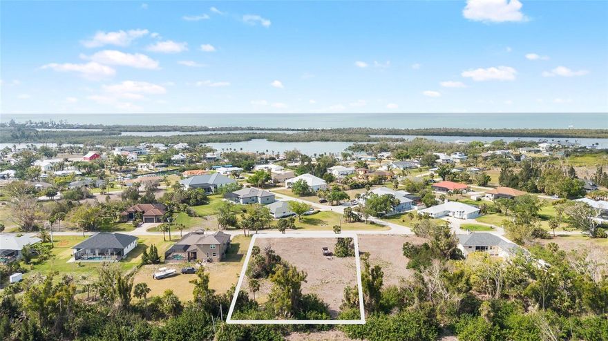 Nestled in the heart of historic Placida, this spacious 0.66-acre lot offers a rare opportunity to build your dream home in one of Southwest Florida’s most charming and timeless coastal communities. Located within a quiet, well-established neighborhood that borders the Intracoastal Waterway, the property combines natural beauty, historical character, and relaxed coastal living. Although the lot itself is not directly on the water, it enjoys close proximity to marinas, public boat ramps, and stunning Intracoastal views, placing world-class boating, fishing, and island-hopping adventures right at your fingertips. The neighborhood is known for its canopy of mature oaks, palms and iconic banyan trees, creating a lush, shaded setting that reflects the authentic spirit of Old Florida. Classic cottages, winding streets, and native landscaping make this a truly unique place to call home. With 0.66 acres of land, there's plenty of space to design a custom home, tropical garden, pool, or even a detached garage or guest suite. The property is located in a community with a voluntary HOA, offering the benefits of a well-kept neighborhood without the burden of mandatory fees. Just minutes away, you’ll find Boca Grande, Gasparilla Island, golf courses, beaches, nature preserves, and local restaurants—all contributing to the area’s laid-back, coastal lifestyle. This is a rare opportunity to own land in one of Placida’s most sought-after and storied neighborhoods. Build your legacy beneath the banyan trees, where history, nature, and the Intracoastal come together in perfect harmony.