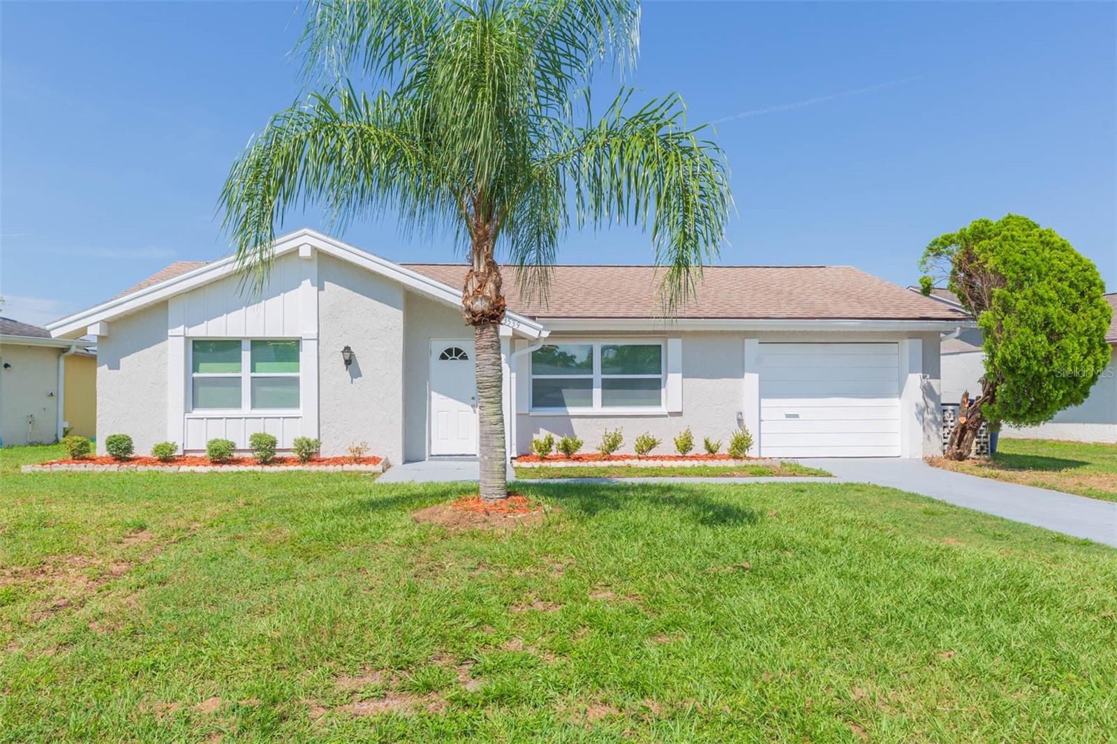 One or more photo(s) has been virtually staged. Completely renovated in 2025, this beautifully remodeled 3-bedroom, 2-bath block home offers a refined blend of modern comfort and natural serenity. Located near scenic waterways and a tranquil bird sanctuary, the home is ideally positioned on a well appointed lot with a partial pond view that enhances its peaceful setting. Inside, the home showcases large-format ceramic tile that complements the light cabinetry, quartz countertops, and stainless steel appliances in the thoughtfully redesigned kitchen. A skylight fills the space with abundant natural light, enhancing the open and airy feel. The spacious primary suite features a generous walk-in closet and an updated en suite bathroom, creating a true private retreat. Enjoy the outdoors from the screened-in lanai, which overlooks a quiet slice of the pond—a perfect place to relax and take in the surrounding nature or a gorgeous sunset. Located just 10 minutes from Sand Bay and the Ben Pilot Point area, the home also offers easy access to tranquil waterways, bird sanctuaries, and shallow bay areas ideal for kayaking, paddle boarding, boating, and fishing. Public launch access is nearby at Anclote River Park, connecting you directly to Sand Bay and the Gulf of Mexico. While the neighborhood has no HOA, anyone may join the Beacon Square Civic Association, offering access to a junior olympic sized pool, rentable event space, a grand ballroom, and a commercial kitchen—ideal for both entertaining and community gatherings.