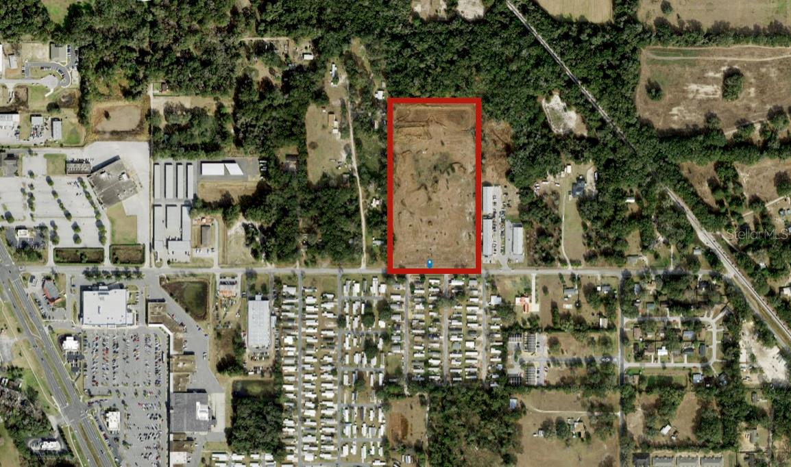MULTIFAMILY DEVELOPMENT OPPORTUNITY, 15.43 Acres, Zoned B2, In City Limits of Belleview strategically positioned as one of the limited options to help fill the workforce rental supply void of the immediate area. Offering represents prior 166 Unit Townhouse development with underground & lift station completed in 2005. 15.43 Acres located in City Limits of Belleview between The Villages and Ocala, convenient to new Publix, Schools, Retail & Restaurants. Although City addition of “Business District” in 2013 changed density to 124 units, P&Z is supportive of change to increase density back to 166 unit development as permitted in 2007-2010 for this development. Seller will allow time for needed modifications. Prior Site Plan & Architectural Plans Available Include: • 8 Apartment Buildings. • Clubhouse & more.
