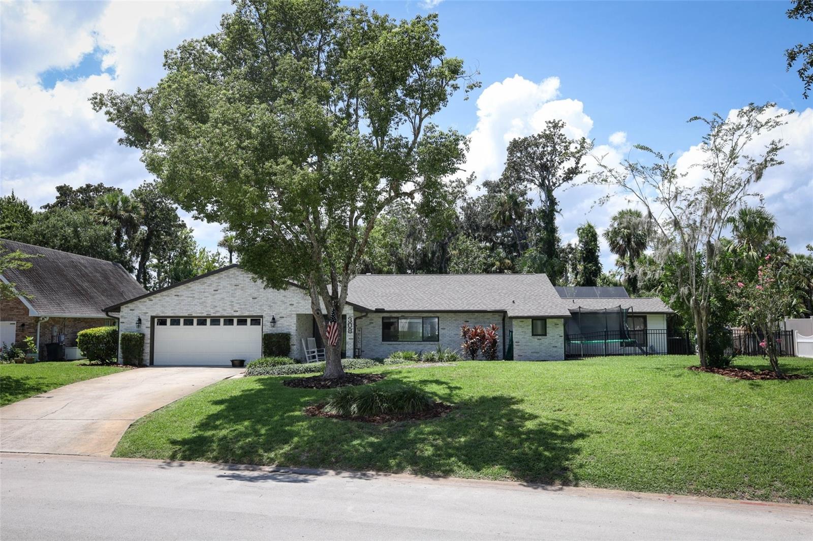 **BEAUTIFUL POOL HOME ON THE RIVER** This property features a PRIVATE 900-ft dock/nature trail over marshland leading to a covered boathouse with lift, water, and electric. Inside, the custom kitchen boasts of solid wood cabinets, granite countertops, stainless steel appliances, a center island with an opening to a great room with hardwood floors, a built-in desk area, and a wood-burning fireplace. Split floor plan plus a **unique 5th bedroom/bonus with full bath, accessed from the lanai—ideal for in-law suite, private office, or guest retreat.** Outdoor living includes a fenced yard, screened pool with a new pump and pool heater, wooden deck for barbecuing, and fresh exterior paint. Updates: NEW ROOF 2025, hot water heater (2024), dishwasher (2025), Refrigerator (2022), New pool/patio Screen enclosure, retaining wall, and side yard fencing. Extras: irrigation with private well, gutter covers, generator plug, and pest control paid for a year. Minutes to shopping, dining, and the beach! **Buyers are advised to verify all measurements and information.**