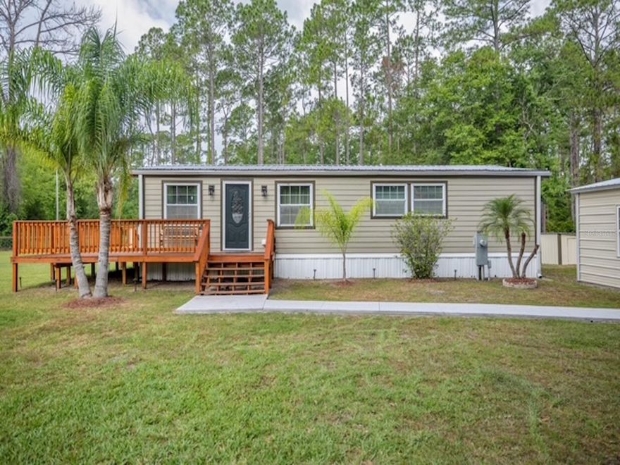 Your dream home awaits! This property has everything to offer AND more!! The home is a newly updated 2/2 with tile flooring throughout and sits on over 2 acres. The rustic charm flows with newly updated counter tops, cabinets, flooring and interior paint. The exterior of the home is sided with hardie-plank, and was freshly painted. The home has a NEW wrap around deck (380 FT!!). The house is equipped with a generator to provide power to the entire home with hookup installed. The property just keeps giving!! Near the home is a 3 car detached garage (20x30). Along with an in-ground pool (24x45), completely screened in with a concrete patio.. you can't forget the exterior lights above the swimming pool which creates a beautiful scenery at night. Enjoy the unique and peaceful pond, with a walking wood dock leading to the island! On the property is ANOTHER detached 2 car garage (20x24) with a carport attached (20x24). The property is newly fenced with wood fencing on the side, and the front fence/wall is concrete, WITH electricity in each pillar for extra durability and privacy! WAIT there is more! There is an RV hookup (50 AMP), TWO wells and TWO septic's!! Come take a look for yourself, and really see the opportunities this property has to offer!