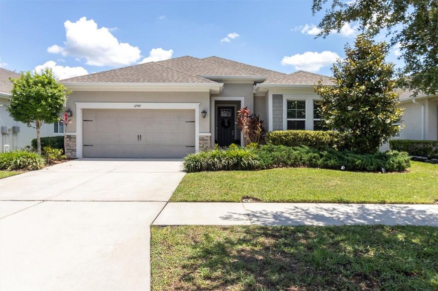 Nestled in the highly sought-after community of Asturia, this beautifully maintained David Weekley home combines timeless style, thoughtful upgrades, and an unbeatable location. Offering 3 bedrooms, 2 bathrooms, a flex room ideal for an office or den, and 1,901 square feet of living space, this thoughtfully designed one-story floor plan is perfect for both everyday living and entertaining. The charming exterior showcases stone accents, shakes wood siding and lush landscaping that create exceptional curb appeal.  Step inside to discover warm wood-look tile flooring throughout the main living areas, neutral designer paint tones, and an open-concept layout filled with natural light. The spacious kitchen is truly the heart of the home, featuring 42” maple shaker cabinetry with crown molding, quartz countertops, stainless steel Whirlpool Gold Series appliances with brushed nickel finishes, a subway tile backsplash, and a large island perfect for gathering with family and friends. The adjoining dining and living areas flow seamlessly together, creating an inviting space for hosting or relaxing at home. Sliding glass doors open to the extended lanai and fully fenced backyard, offering a peaceful outdoor retreat with plenty of room to unwind, dine, or entertain.  Privately tucked away, the primary suite offers a relaxing escape complete with tray ceilings, bay windows, a large walk-in closet, and a beautifully appointed ensuite bath featuring dual quartz vanities, upgraded tile flooring, shaker cabinetry, a garden tub, and a frameless walk-in shower. Two secondary bedrooms and a full guest bath are situated near the front of the home, providing privacy and flexibility for guests or family members, while the flex room offers endless possibilities for a study, den, or playroom.  Additional highlights include recessed lighting throughout the main living areas, 8-foot doors, built-in drop zone, pull-down attic access with plywood flooring for additional storage above the garage, epoxy garage flooring, Taexx in wall pest system and a fully fenced backyard.  Residents of Asturia enjoy exceptional amenities including a resort-style pool, fitness center, playgrounds, scenic walking trails, dog parks, and year-round community events — all conveniently located near shopping, dining, beaches, and Tampa International Airport. Stylish, functional, and located in one of Odessa’s most desirable communities, this home is ready to impress from the moment you arrive.