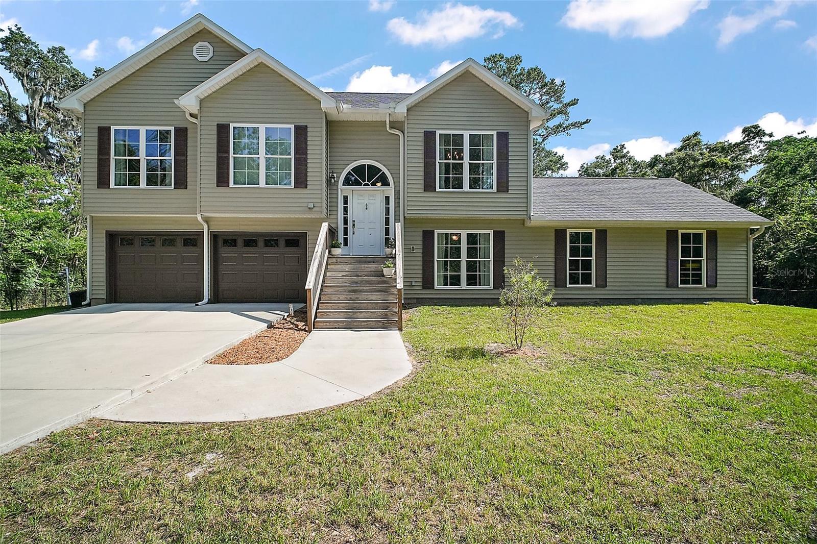 CUSTOM BUILT!! This home boasts 4BR, 3 FULL BATHS, (2) TWO CAR ATTACHED GARAGES and is NESTLED ON 3.9 ACRES IN BELLEVIEW. Enjoy Morning Coffee or your Favorite Beverage on either of the 2 BALCONIES. One is located off the Primary Bedroom and the other is off of the Kitchen. Both have an AMAZING VIEW of your totally FENCED in property, or you can Barbecue on your PATIO just off of the Den. Both Kitchen Deck, and Outdoor Patio are have a Propane Gas Connection for your Grill, no more refilling those propane tanks, since there is a 300 lb. propane tank buried on the property. Home also has a WATER FILTRATION SYSTEM and has a Connection for a PORTABLE GENERATOR. DUAL AC, One for Upstairs and One for Downstairs. VAULTED CEILING in Living Room. 9Ft ceilings upstairs and 8Ft ceilings downstairs. Kitchen has 42inch Cabinets with a CLOSET PANTRY, GRANITE COUNTERTOPS and STAINLESS-STEEL APPLIANCES. Primary Bedroom has a WALK-IN CLOSET. Primary Bath has a CLAW FOOT TUB to soak in after a long day... On the first floor you will find your LAUNDRY ROOM, DEN (Which is PLUMBED for a WET BAR and ICE MACHINE), 4th BEDROOM (no closet) and the 3rd FULL BATH, which leads to the 23x23 GARAGE/WORKSHOP, which is plumbed for a Utility Sink. Above the GARAGE/WORKSHOP you will find that PLYWOOD covers the entire floor. Looking for a bit more storage? There's a 12x24 SHED which is wired for ELECTRICITY. Not to mention the other 21x22 (2) CAR GARAGE and the 8x22 UTILITY ROOM (air-conditioned). This Home Has it ALL!! Call for your private showing today.