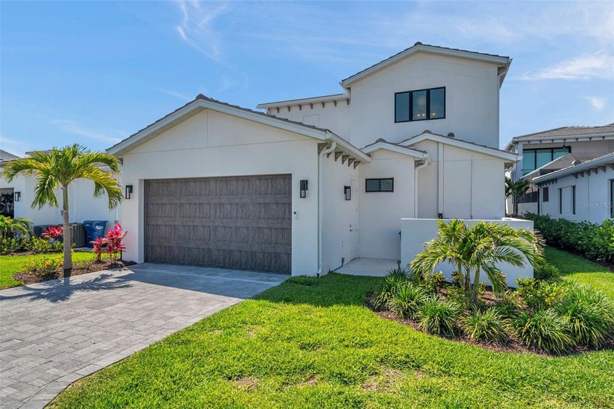 $85K price adjustment!  Welcome to one of the most expansive and upgraded homes in the private, gated community of Aqua- thoughtfully designed with IMG Academy families in mind. Spanning nearly 4,300 square feet, this custom-built Salt Meadow model offers 5 bedrooms, 6 bathrooms, and an unmatched blend of luxury, comfort, and efficiency.
Every detail of this residence has been carefully curated. Soaring 10-foot ceilings on both levels, tray ceiling accents, and oversized windows create a bright and airy atmosphere. Each bedroom features its own ensuite bathroom and walk-in closet, providing privacy and convenience for family and guests alike.
The gourmet kitchen is the heart of the home, extended by six feet to accommodate a stunning 7-by-12-foot island- ideal for entertaining, cooking, and gatherings. Custom cabinetry with Flemish glass, quartz countertops, premium appliances (including a built-in air fryer, wine refrigerator, and canopy range hood), and upgraded hardware elevate both function and style.
The main suite comes with a custom oversized walk-in closet, complete with quartz-topped center island, premium shelving, and an abundance of natural light coming through the large window- all creating a boutique dressing experience. The primary bathroom features an upgraded freestanding soaking tub and elegant finishes. A second primary suite is located just across the hall- ideal for multigenerational living or guests seeking additional privacy and comfort. Its ensuite bathroom includes both a freestanding tub and a walk-in shower.
The home also features a dedicated office on the second floor, two ensuite bedrooms on the main level for flexible living arrangements, and custom lighting and window treatments.
High-end finishes continue in the bathrooms, where frameless glass shower enclosures, full-height tile, and modern fixtures create a cohesive, upscale feel. Luxury flooring spans the entire home- completely carpet-free.
Practical upgrades include spray foam insulation, whole-house surge protection, and an extended garage- lengthened by an additional six feet- with epoxy-coated flooring.
A private service area provides concealed access to HVAC systems, trash, and pool equipment.
 Outdoors, enjoy a screened lanai with motorized shades and a saltwater heated pool - perfect for relaxing or entertaining year-round.
Located just minutes from IMG Academy and the best beaches in Florida, this one-of-a-kind home offers exceptional craftsmanship, space, and convenience in one of the area’s most sought-after locations. Don’t miss the opportunity- schedule your private showing today.