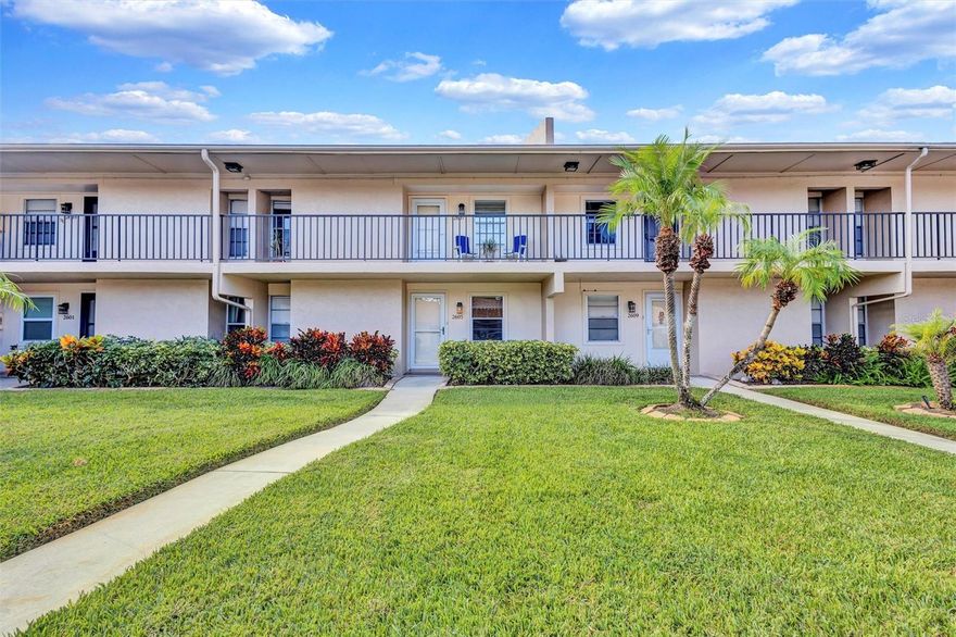 Welcome to Pinewood Village, a hidden gem in the heart of Sarasota! This spacious 2-bedroom, 2-bath condo has been freshly painted and features new carpeting along with ceramic tile flooring. The split floor plan is filled with natural light and includes an enclosed lanai with sliding glass doors and screens, offering beautiful views of the sparkling community pool. The kitchen provides generous cabinetry and counter space, opening to the dining and living areas—ideal for entertaining or relaxing at home. The primary suite includes a walk-in closet and en-suite bath, while the guest bedroom and bath provide comfort and flexibility. An oversized laundry room adds valuable storage, and the assigned carport keeps your vehicle shaded year-round. Pinewood Village offers resort-style amenities including a heated pool, shuffleboard courts, fitness center, and a clubhouse with full kitchen for social gatherings. Ideally located just minutes from Siesta Key Beach, Downtown Sarasota, shopping, dining, and cultural attractions. Schedule your personal showing today! (All room measurements are approximate and should be independently verified by the buyer.)