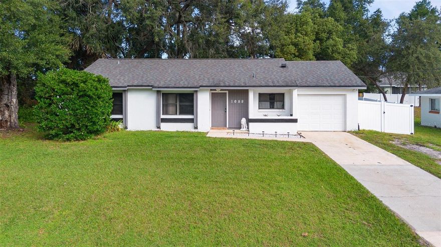 Charming Move-In Ready Home with Modern Upgrades in Deltona! **Downpayment assistance programs available to those who qualify through sellers preferred lender.** Welcome to 1088 N Harbor Dr — a beautifully maintained 3-bedroom, 1.5-bathroom home offering comfort, convenience, and style. Situated on just under a quarter-acre lot, this property features a spacious, fully fenced backyard—perfect for entertaining, pets, or simply relaxing in privacy. Step inside to an inviting open-concept layout with high cathedral ceilings that create an airy and bright atmosphere throughout the living space. The brand-new sliding glass doors open seamlessly to the backyard, extending your living area outdoors. You’ll appreciate the many recent upgrades that provide peace of mind and energy efficiency, including a new water heater, AC replaced in 2023, a newer electrical panel, and a roof replaced in 2018. The smart thermostat adds modern convenience, giving you easy control of your home’s climate. Whether you’re a first-time homebuyer or looking to downsize, this home is move-in ready and waiting for you to make it your own. Conveniently located near Gemini Springs, parks, shopping, dining, and major highways, this home combines modern updates with everyday comfort. Don’t miss your chance to see this one in person — schedule your private showing today!