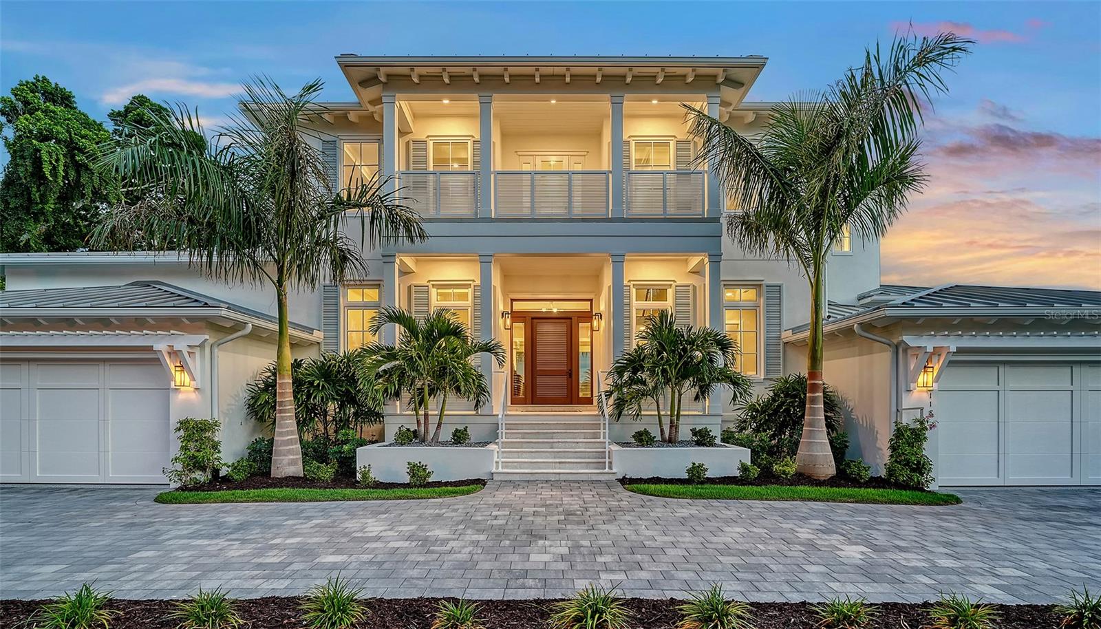 Heritage Builders proudly presents The Sand Dollar, a truly one-of-a-kind waterfront estate located in the prestigious, gated community of Bird Key. This architectural masterpiece blends timeless Caribbean-inspired design with the best of modern luxury and functionality. Spanning 4,594 sq. ft. of living space and 6,952 sq. ft. under roof, this expansive custom residence offers 4 bedrooms, 4 full baths, and a half bath. A 3.5-car garage provides ample room for vehicles plus a golf cart—perfect for quick trips to downtown Sarasota or the world-renowned St. Armand's Circle. Upon entering through the wide gallery with soaring 12-foot ceilings, you’re greeted by elegant oak flooring and a striking quartz-clad fireplace, setting the tone for the home’s warm yet sophisticated ambiance. The heart of the home is the chef’s-grade kitchen, featuring Thermador appliances, a wine column, polished stainless steel hood with standing seams, and a grand center island—all seamlessly integrated into the open living and dining areas. A dramatic wall of 10-foot sliding glass doors fully retracts to reveal a spacious covered patio, infinity-edge pool, and sweeping long water views—a breathtaking backdrop for relaxing or entertaining. The outdoor living space is curated for coastal luxury, with dedicated lounge areas, conversation nooks, and al fresco dining zones. Upstairs, the second level offers a private guest master suite, a guest lounge, a flexible library or media room with balcony access, a second study or home gym, and an expansive rear terrace overlooking Sarasota Bay. Additional features include a private boat dock, jet ski lift, and direct water access to Sarasota Bay and the Gulf of Mexico. Located in one of Sarasota’s most coveted neighborhoods, Bird Key offers unmatched proximity to Lido Key’s award-winning beaches, downtown arts and dining, and St. Armand's Circle’s boutique shopping and entertainment.
