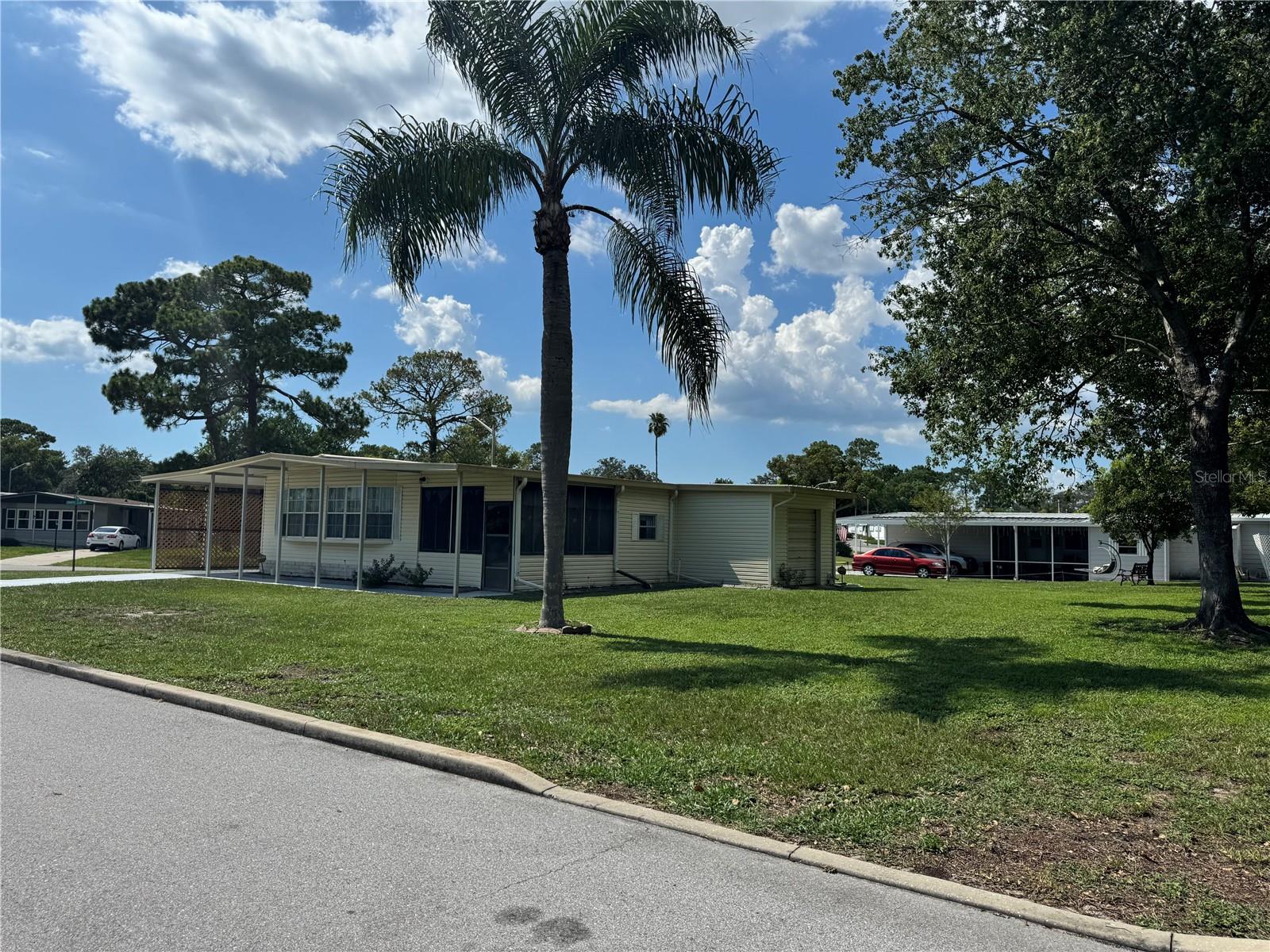 This 55+ gated community features an 18-hole golf course, Olympic size pool, tennis courts, clubhouse events, and more. The house sits on a double corner lot with a circular drive, offers two bedrooms, 1.5 baths, a spacious kitchen and living room, and bright bay windows. Additional perks include a storage shed with laundry space and a golf cart garage.