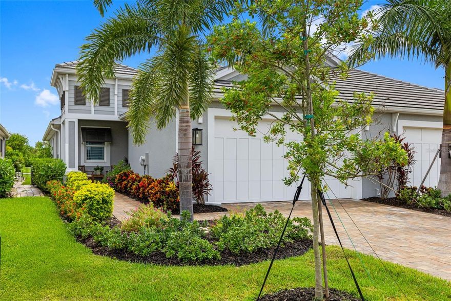 No CDD and right on a prestigious golf course with tropical views. Located within the gated community of Watercolor Place, this 2022-built coastal-style villa perfectly blends modern luxury with low-maintenance living. Built with IMPACT WINDOWS AND DOORS, it offers lasting durability and peace of mind. The exterior showcases a tile roof, paver driveway and sidewalks, and lush tropical landscaping, creating an inviting curb appeal. This desirable Captiva floor plan features 2 bedrooms, 2 baths, a private den with doors, and a 2-car garage. Inside, a light-filled, open-concept design is enhanced by a soothing neutral palette, tray ceilings, plantation shutters, wood-look plank tile flooring, and upgraded ceiling fans throughout. The chef’s kitchen is a true highlight, boasting smart appliances, a gas cooktop with hood, convection oven/microwave combo, quartz countertops, a center island with breakfast bar, and a spacious pantry. The primary suite offers a walk-in closet and a spa-like en-suite bath with dual vanities and a private water closet. Step outside to the screened lanai and take in serene views of the golf course, pond, and wooded backdrop—perfect for morning coffee or evening gatherings. With no CDD fee and an affordable HOA that includes cable, internet, lawn care, and access to recreation facilities, this home provides exceptional value. Community amenities include a clubhouse with pool, spa, and outdoor grilling area. Ideally located near I-75, this home offers an easy drive to Sarasota, St. Petersburg, Tampa, and the stunning west coast beaches, with multiple airports also within an hour’s drive. Costco, shopping, brand new Target and dining are just minutes away, putting the best of Florida living at your fingertips. Schedule your private showing today and experience the lifestyle Watercolor Place has to offer!